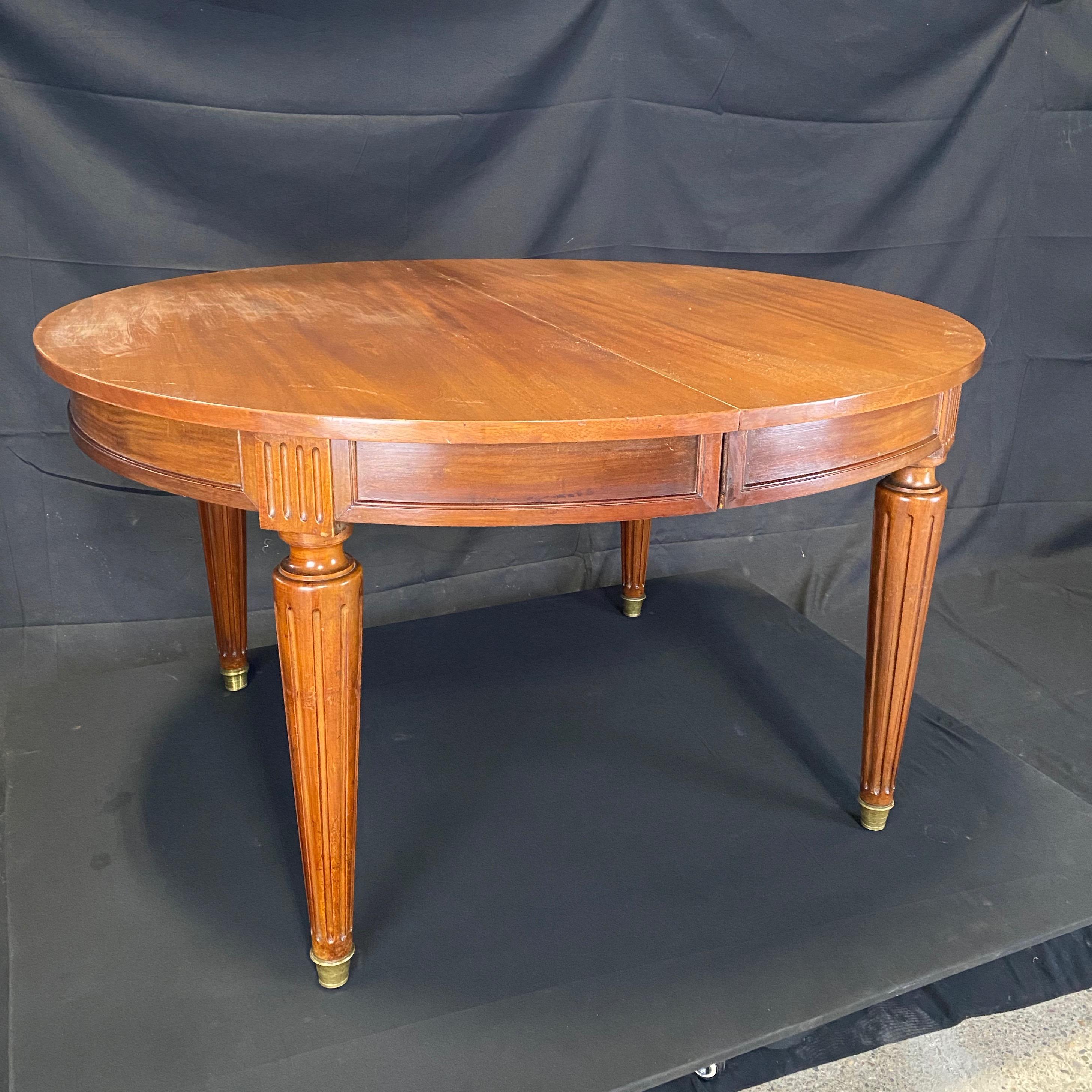 Lovely oval Louis XVI table from Lyon, France could serve many uses: as an entry or statement table, as a lovely floating desk, as a smaller dining table for 4, or expand to a 7'5
