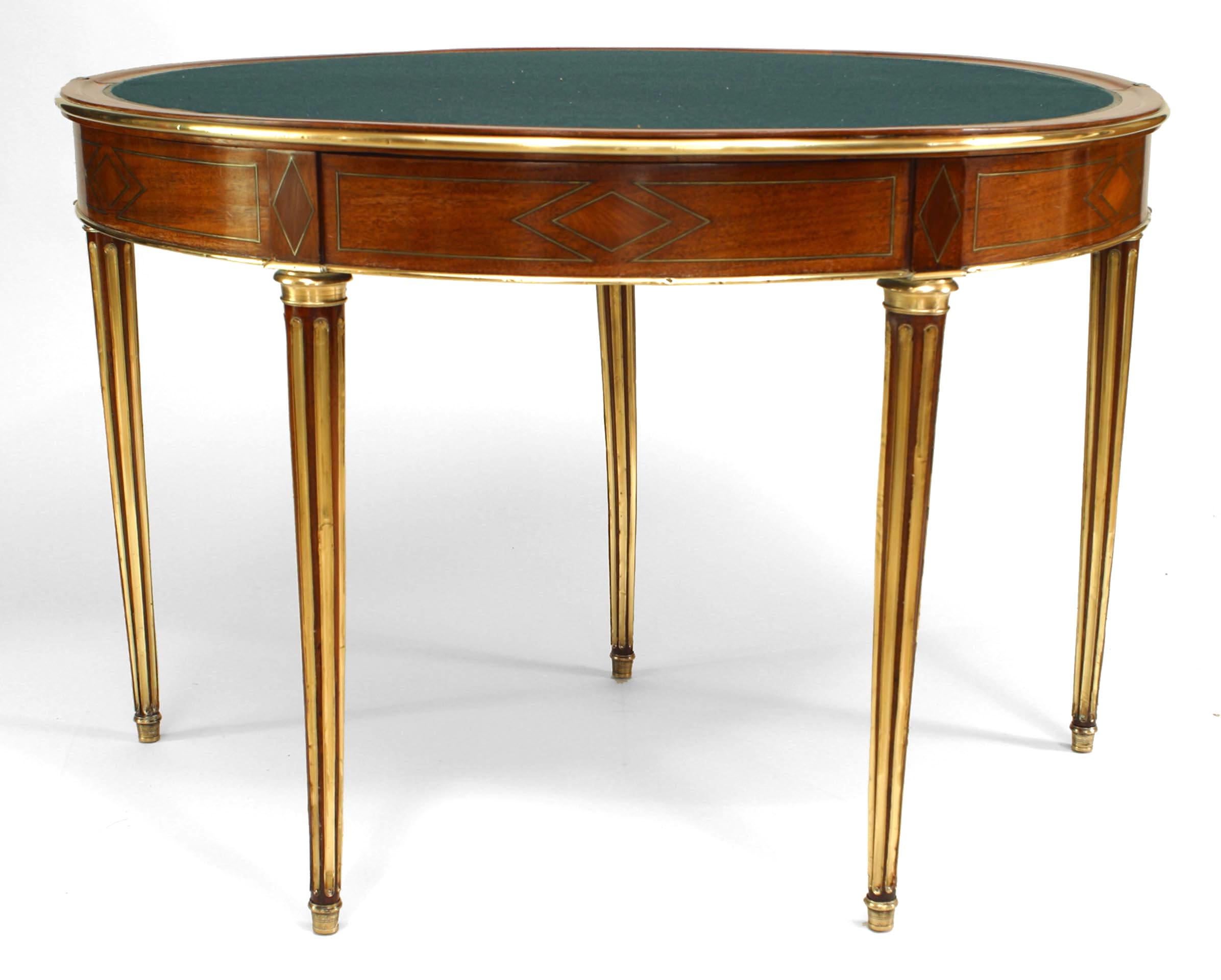 French Louis XVI mahogany and inlaid flip top demilune shaped console card table with brass fluted legs and trim with green felt top with fifth leg as drawer
