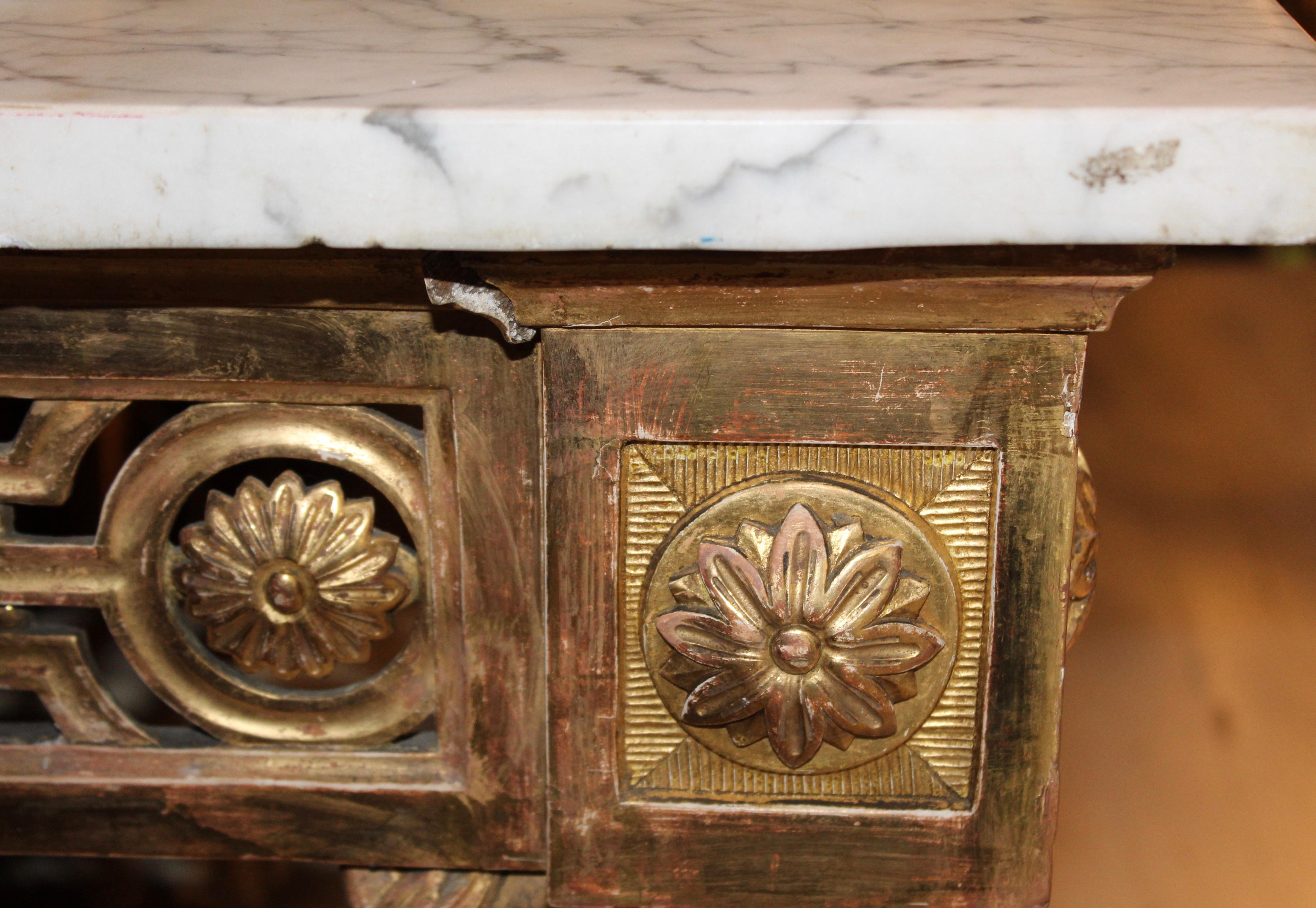 Very impressive large freestanding Louis XVI giltwood console table, France, circa 1790. The rectangular white marble top with grey veins sits comfortably on the water gilded frame. The apron with fine and delicate carving of weaving foliate motifs