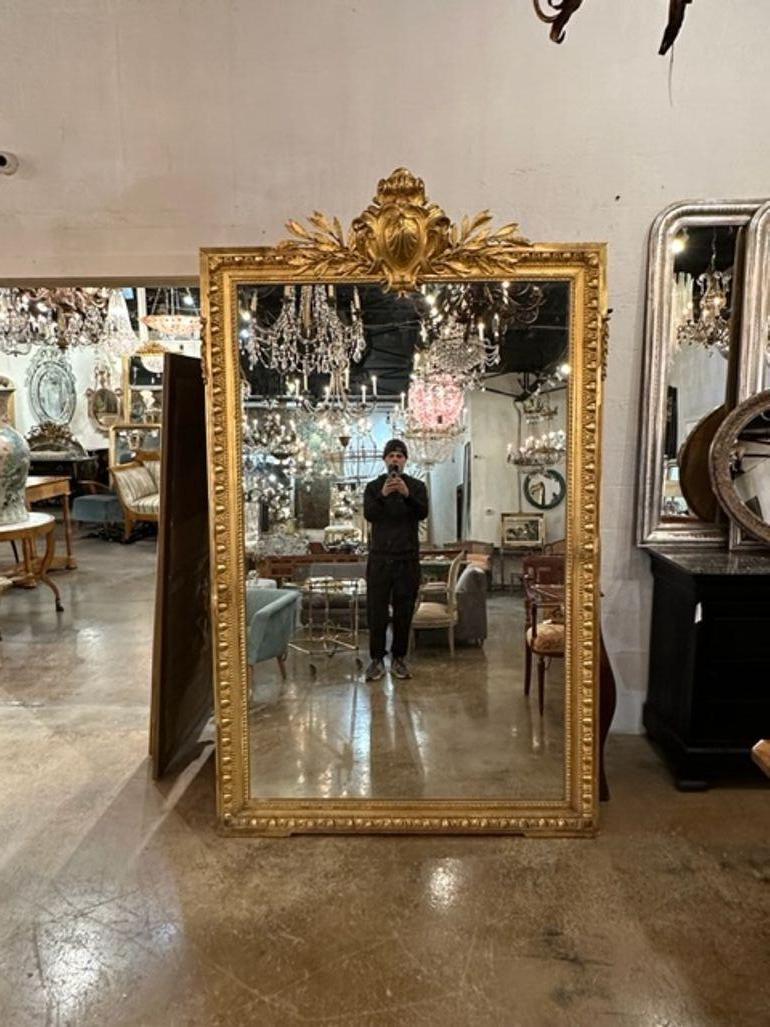 Fine 19th century French Louis XVI large scale carved and giltwood floor mirror. Circa 1860. Sure to make a statement!