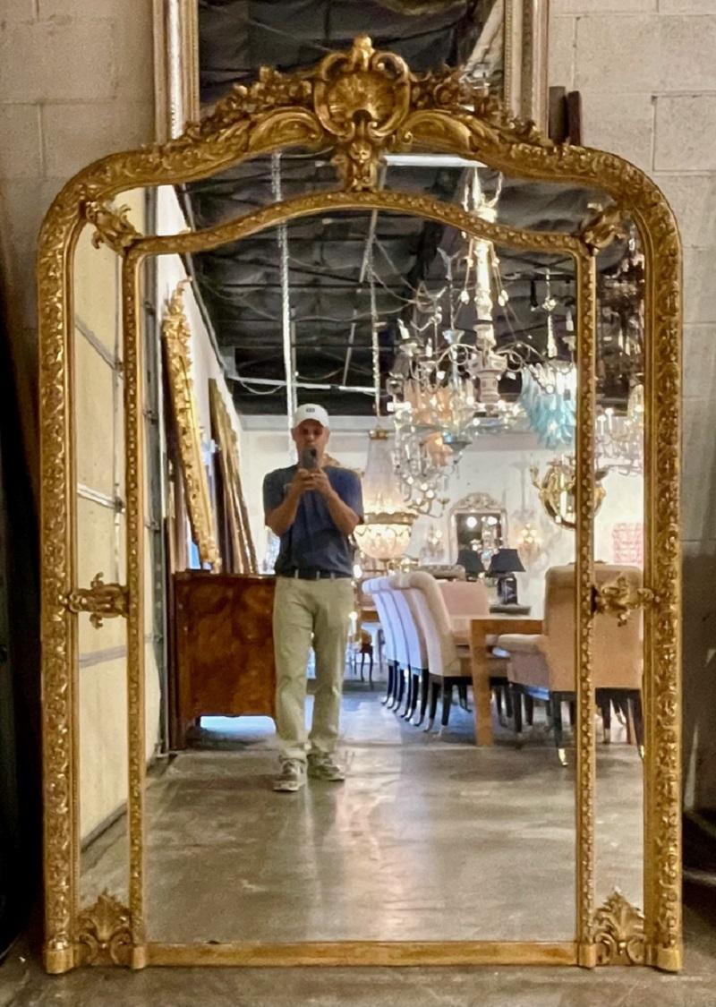 19th Century French XVI style large scale carved and giltwood mirror. Circa 1870. A fine addition to any home!