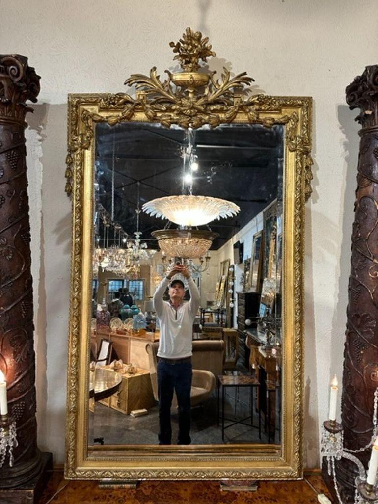 19th century French Louis XVI carved and giltwood mirror. Circa 1870. Adds warmth and charm to any room!