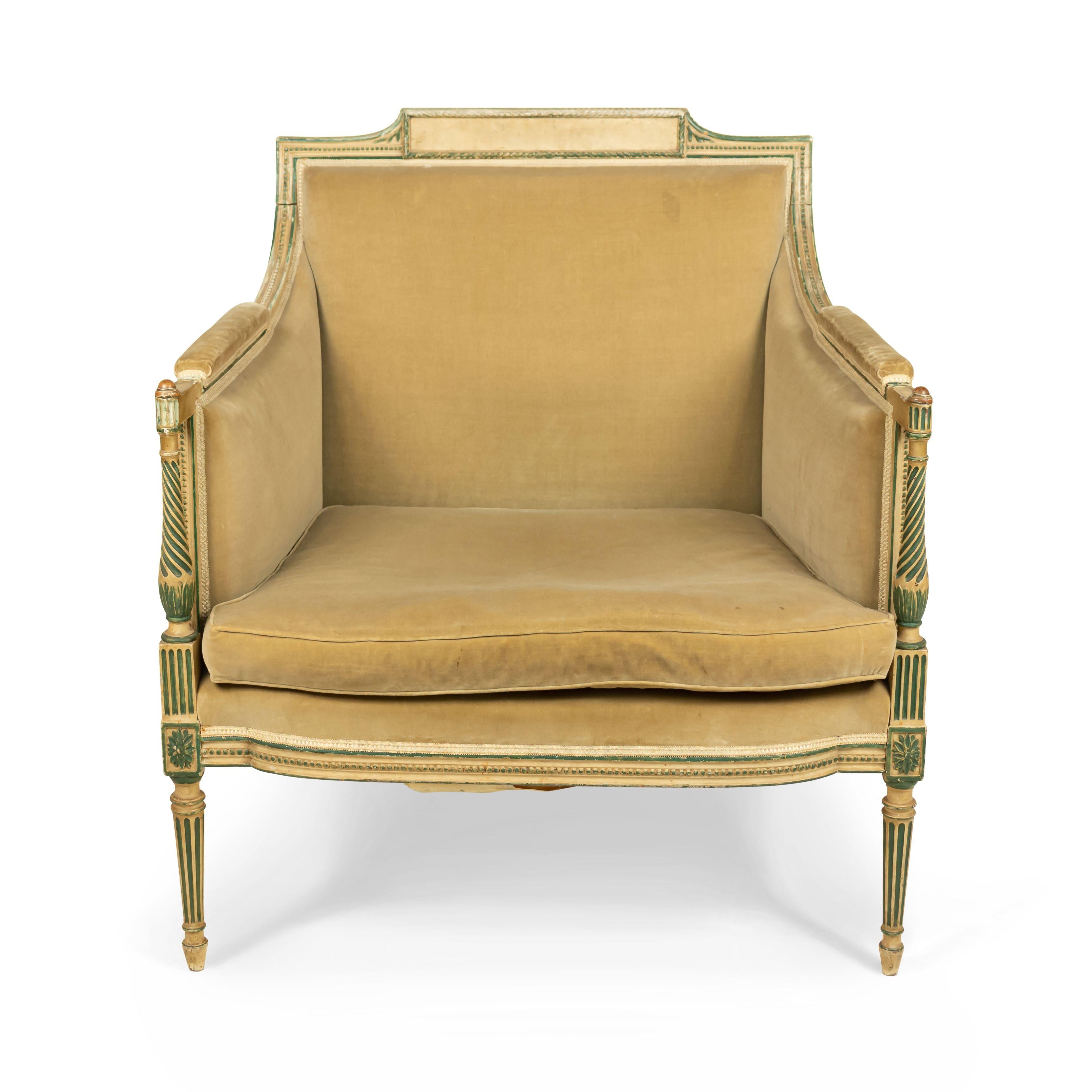 French Louis XVI painted gold and green trimmed bergère (Marquis) with gold upholstery.