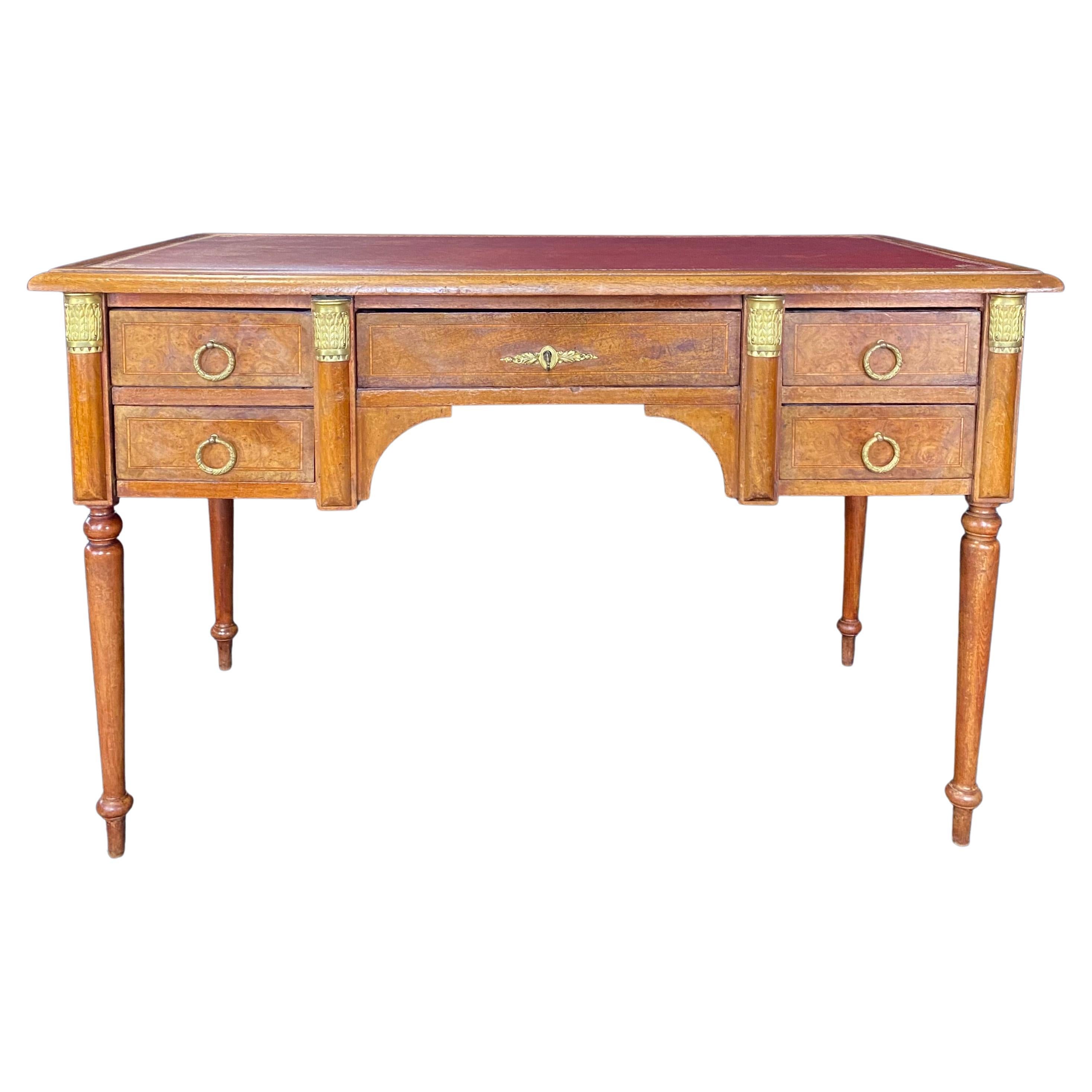 Just in from Avignon - this lovely French Louis XVI burled walnut desk has an inlaid molding on all five drawers and a beautiful red embossed leather top. Original key included. H skirt of opening 24.75” W opening 19
 #6159.

 