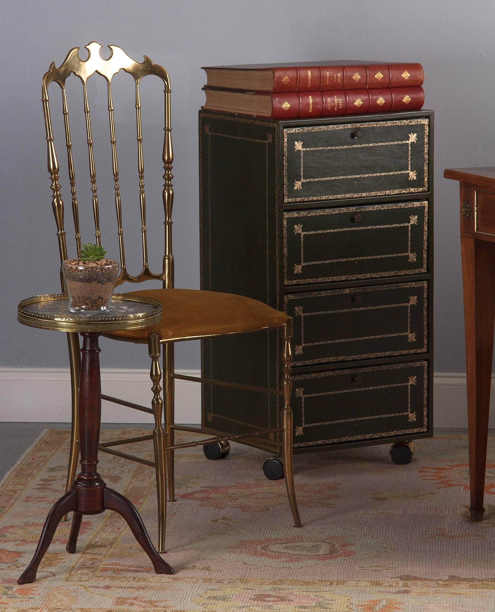 A petite vintage Louis XVI style mahogany gueridon round table with gray marble top, French, circa 1940. Red-tinged mahogany stand with baluster turning is topped by a small round marble top with a pierced brass gallery. Three curved legs support