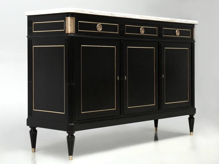 French Louis XVI style ebonized buffet. Our Old Plank workshop carefully removed the old finish without the use of any harsh chemicals and applied an ebonized finish. This French Louis XVI style buffet has a little more age to it than most of the