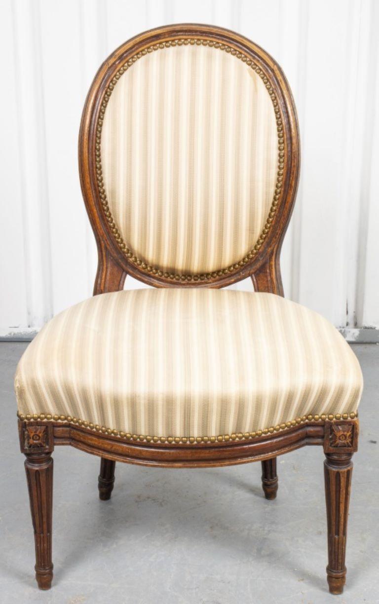 Paire de chaises d'appoint ou de salle à manger de style Louis XVI, les chaises à patins sont recouvertes d'une tapisserie rayée et ornées de têtes de clous en laiton, probablement de l'époque. Provenance : Provenant de la succession d'Arnold