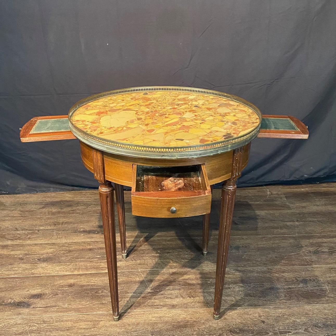  Elegant antique French Louis XVI marble top bouillette or games or side table having gold pierced brass gallery, lovely walnut base with drawers and pull-out green leather topped shelves for game pieces and beverages, all under a lovely Breche