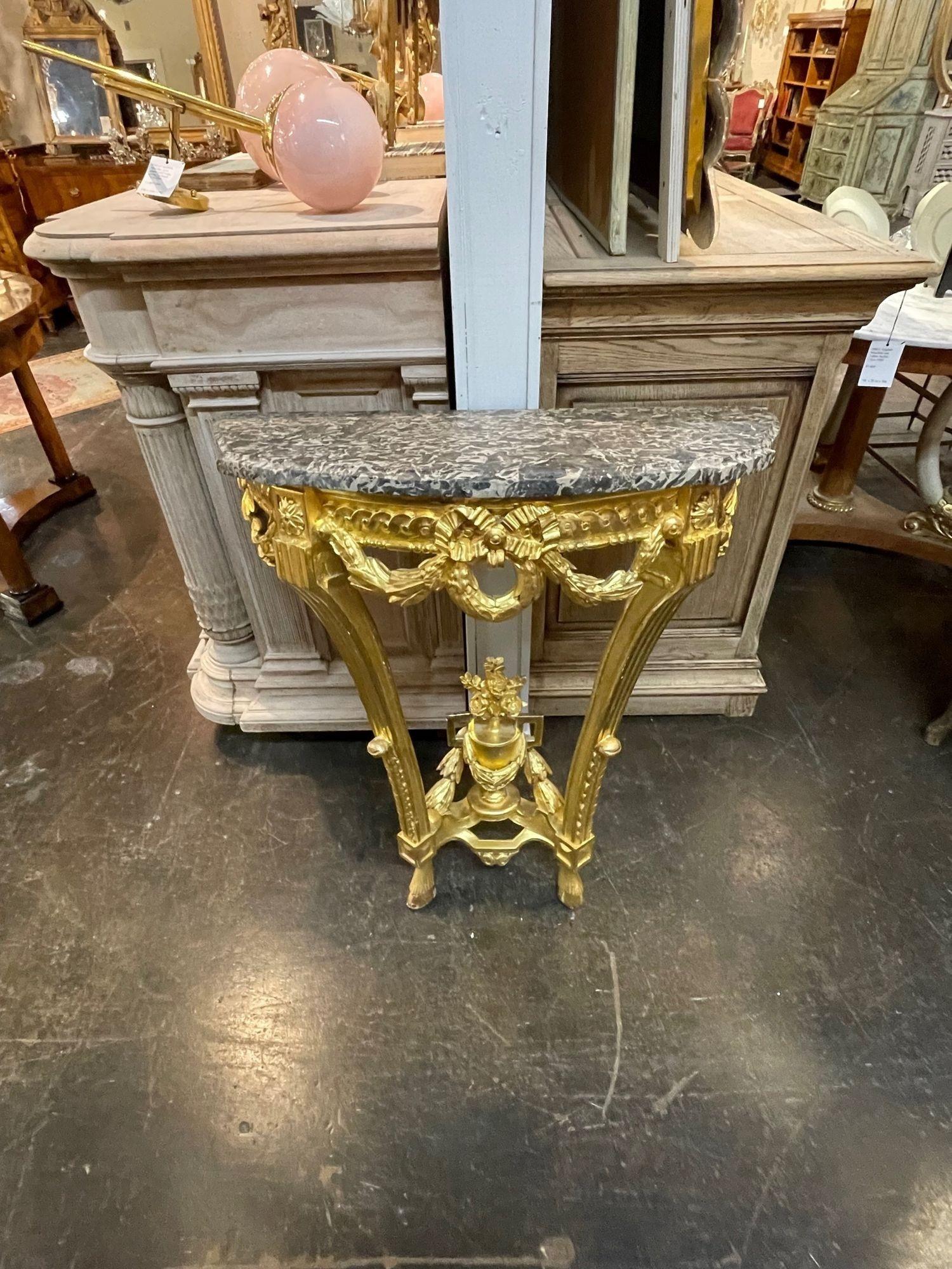 19th century French Louis XVI style carved and water-gilded marble top console. Circa 1860. A fine addition to any home!