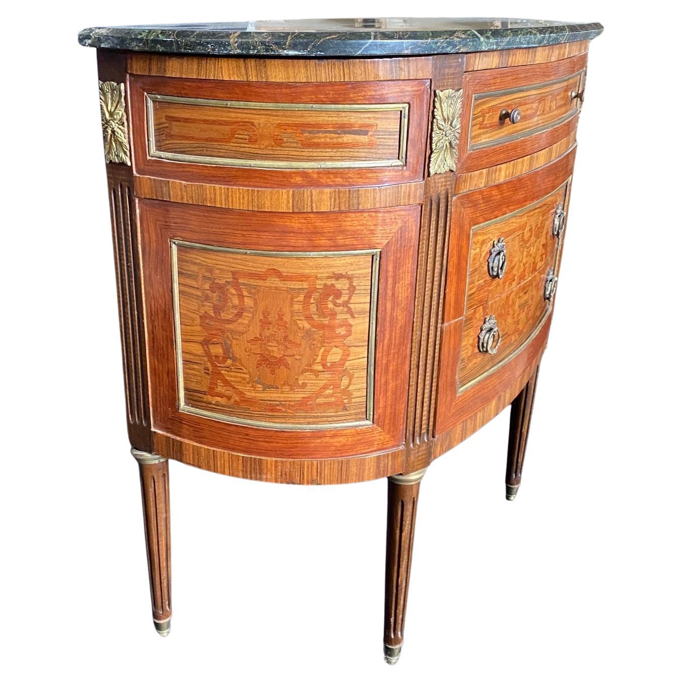 Elegant French Louis XVI demilune marble top commode or console is a remarkable work of art: it features a fully curved casework in a demilune form that presents no corners or sharp edges into the room at all. Hand-crafted from walnut and inlaid