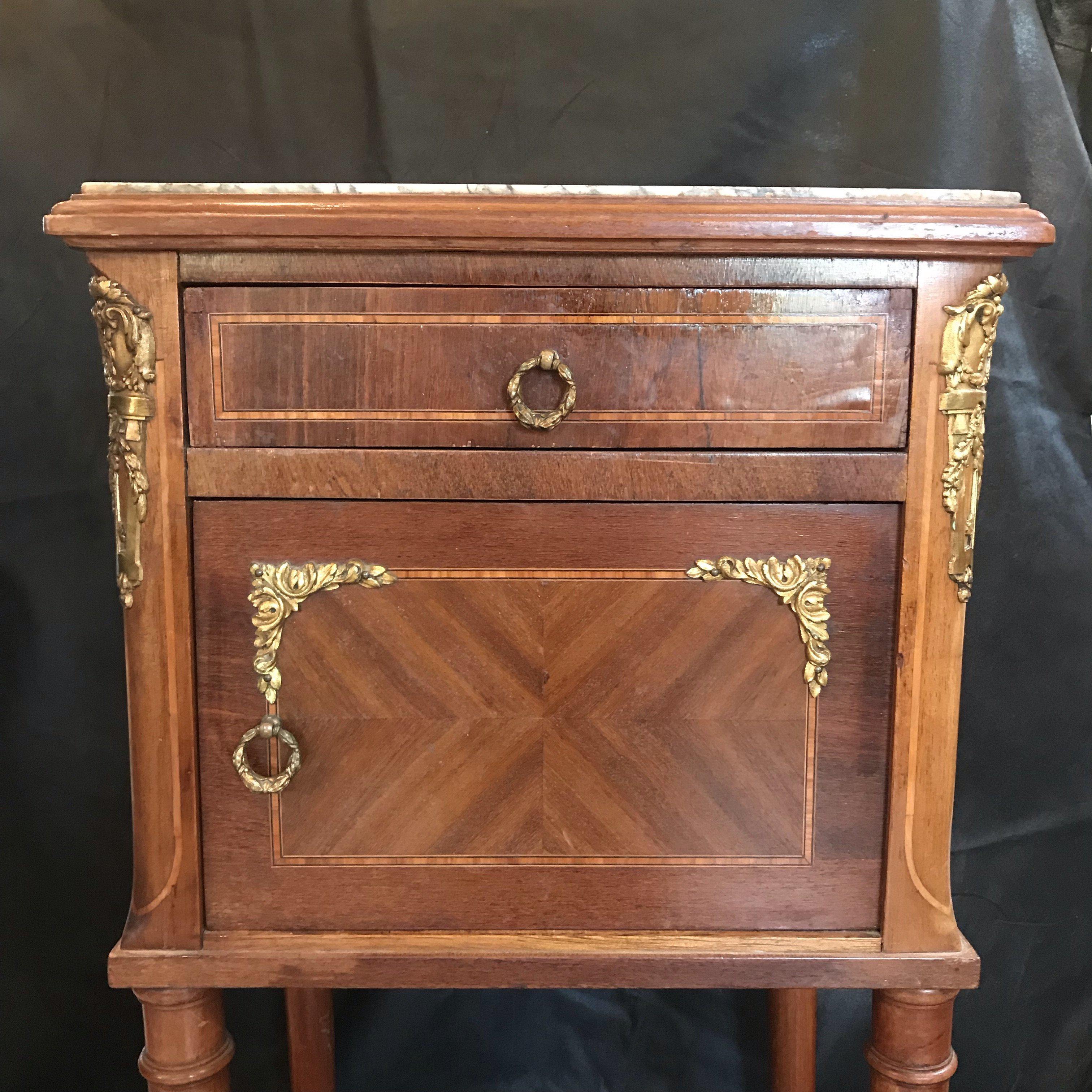 French mahogany and satinwood inlay night stand having gorgeous marble top, single drawer, brass pulls and accents. Minor veneer loss (see photos). Gorgeous marble interior behind single door. #4728.