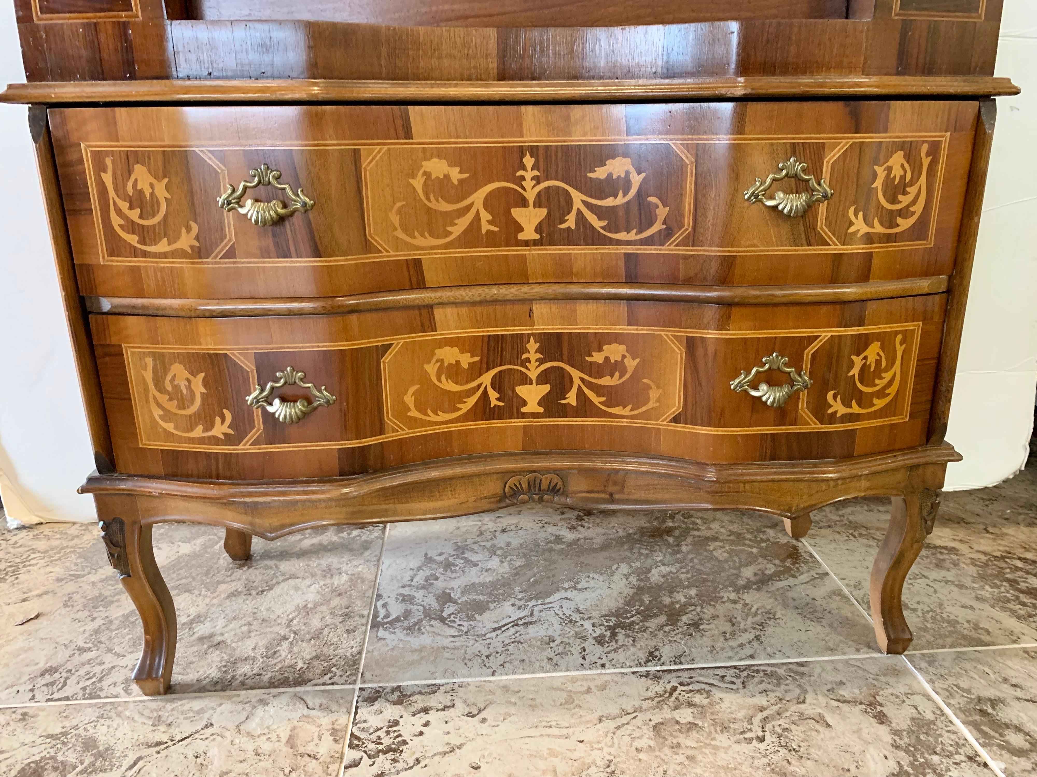 Exquisite French Louis XVI style small secretary desk that features marquetry and inlay detail. The top folds down to reveal a writing surface with small cubbies and drawers. There are two dovetailed drawers on the bottom as well. Finally, all
