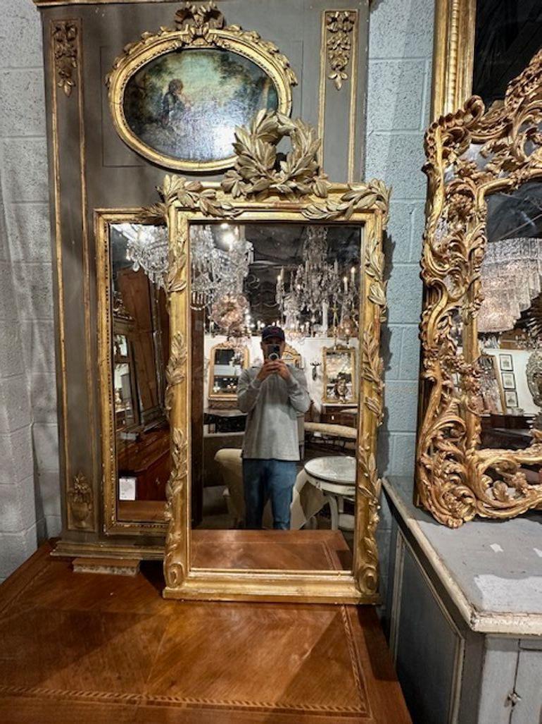 19th French Louis XVI carved and giltwood narrow mirror with leaves. circa 1870. Perfect for today's transitional designs!