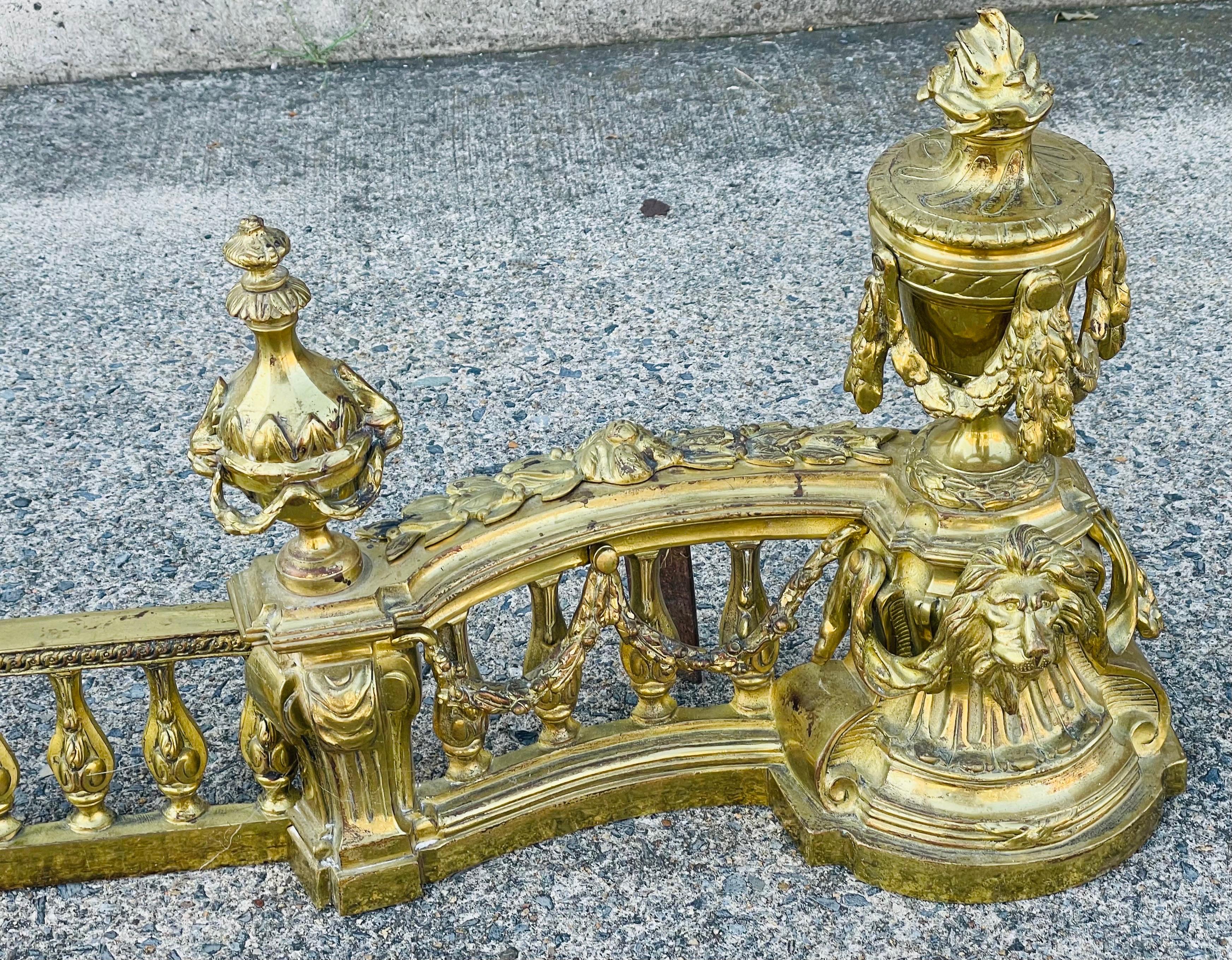 Cast French Louis XVI Neoclassical Urn Lion Head Brass Fireplace Chenets & Fender Set For Sale