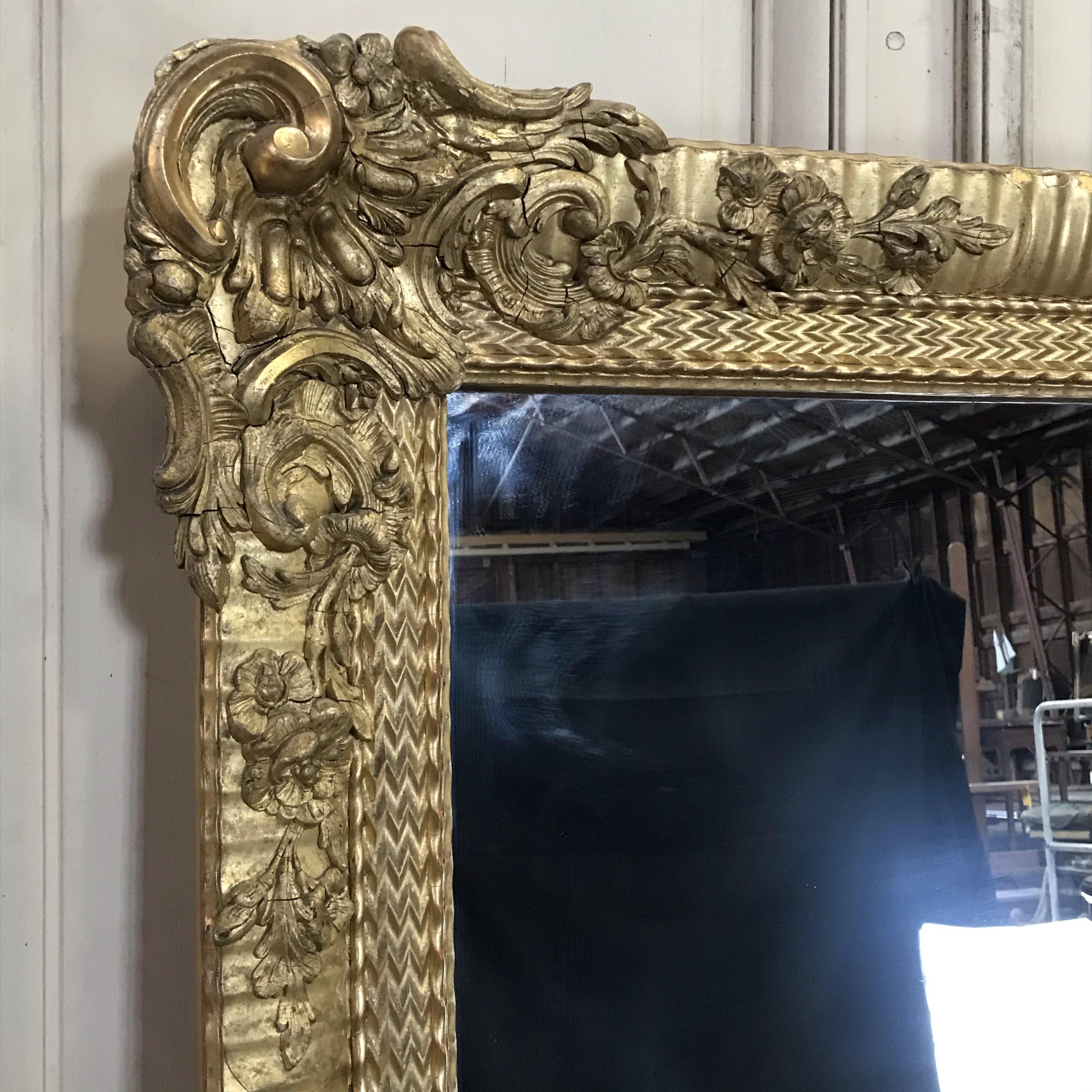 This beautiful gilded mirror in the Louis XVI style has the original mercury glass. The overall patina developed throughout the past century and a half is magnificent. Very tall and beautiful water gilding! Suitable for any room in the