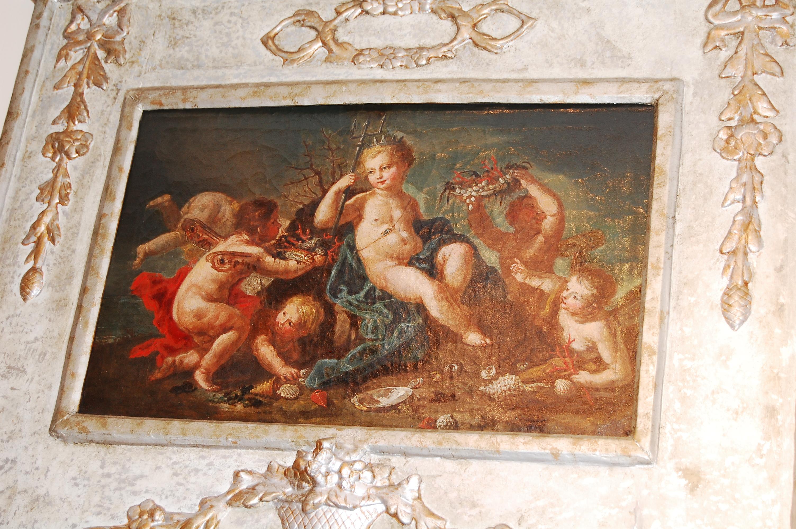 French Louis XVI painted silver gilt trumeau mirror with restored frame bearing low relief basket of flowers and other adornments.  The original oil painting on canvas of putti frolicking relates to the ancient classics.  The mirror is a