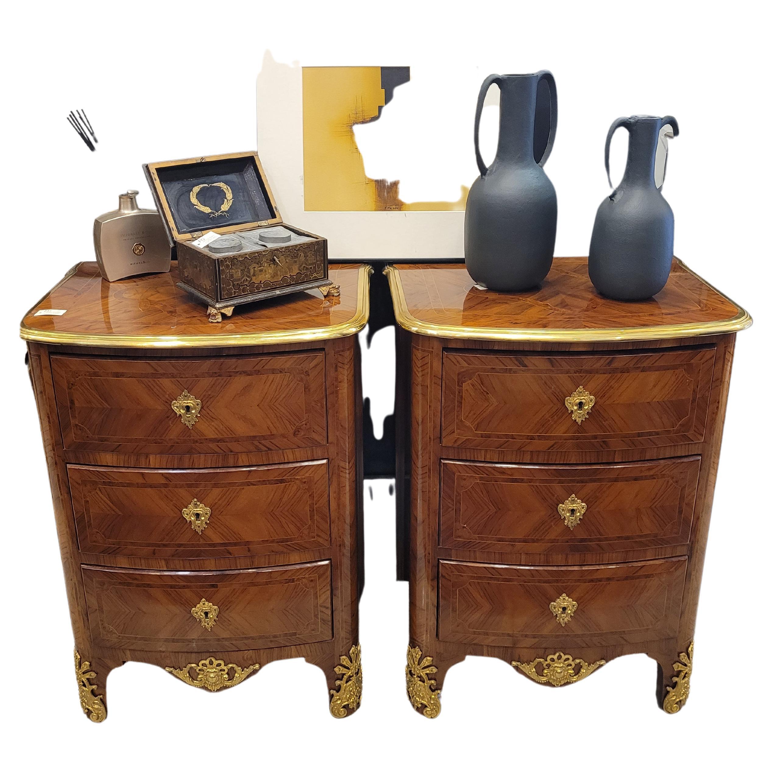 On of a kind pair of small Louis XVI commodes or chest of drawers from France, circa 1800, in marquetry of different woods and ormolu keyholes and keys .
on profiled with gilded bronze to mercury embedded, marking the gently wavy profile.
Legs and