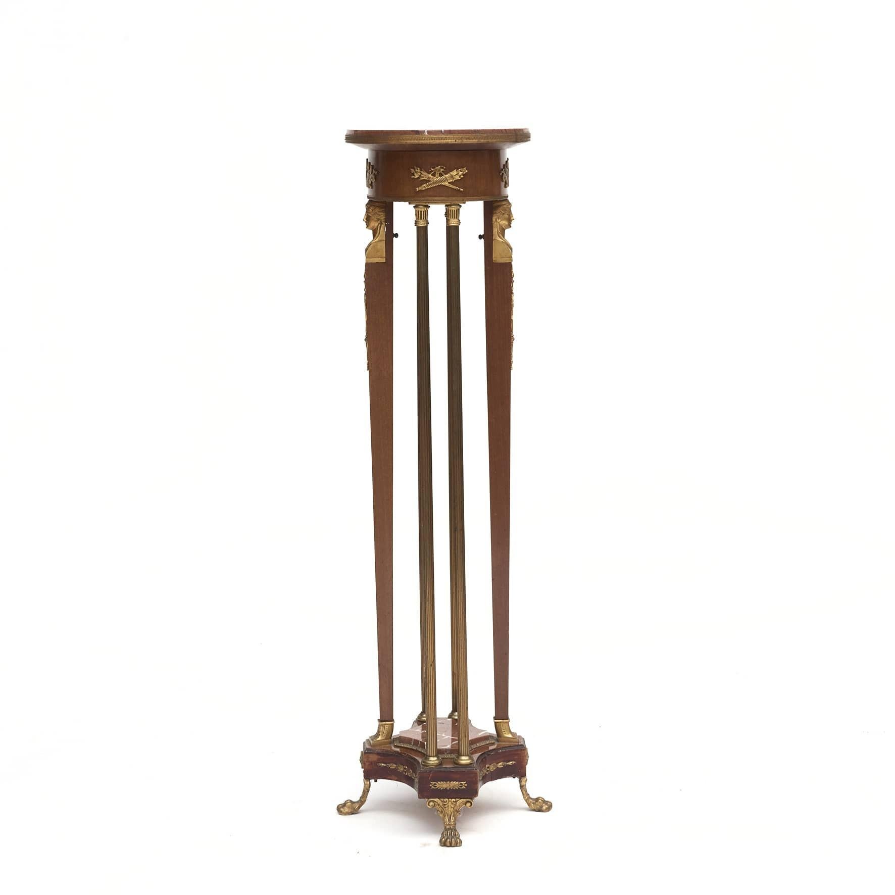 Pedestal Louis XVI style. Mahogany with gilded bronze mounting in the form of swans on the apron under the plate.

Two legs in mahogany, top with gilded bronze heads.
On each side fluted bronze columns.
Base finished with gilded bronze animal