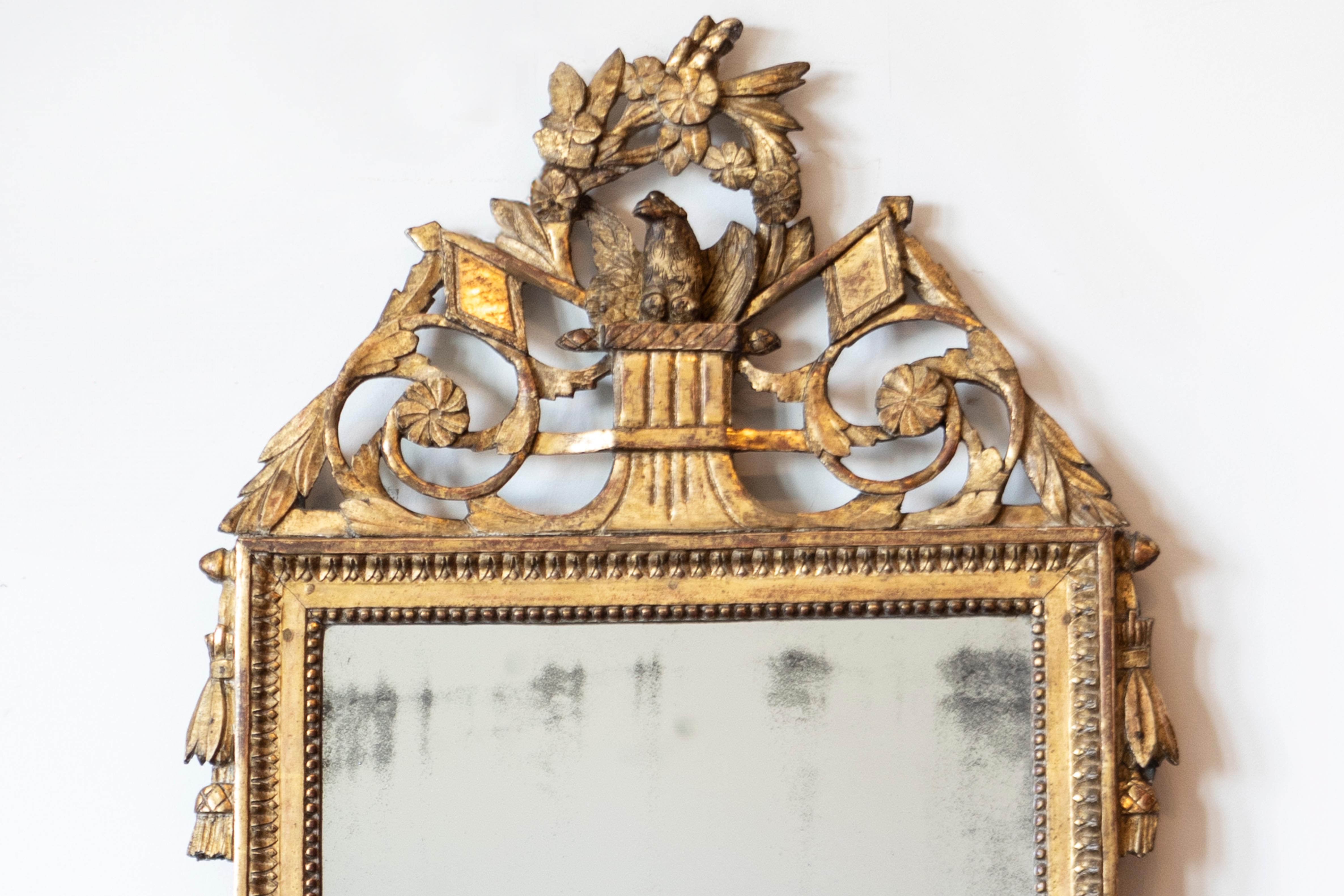 18th Century French Louis XVI Period 1790s Giltwood Mirror with Carved Bird and Flags For Sale