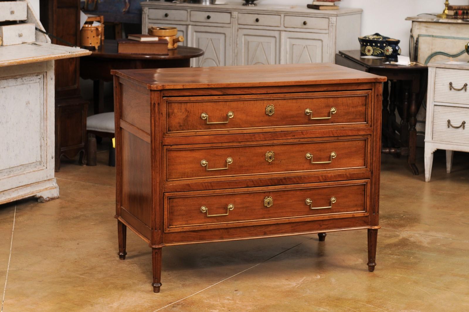 Carved French Louis XVI Period 1790s Walnut Three Drawer Commode with Fluted Side Posts For Sale
