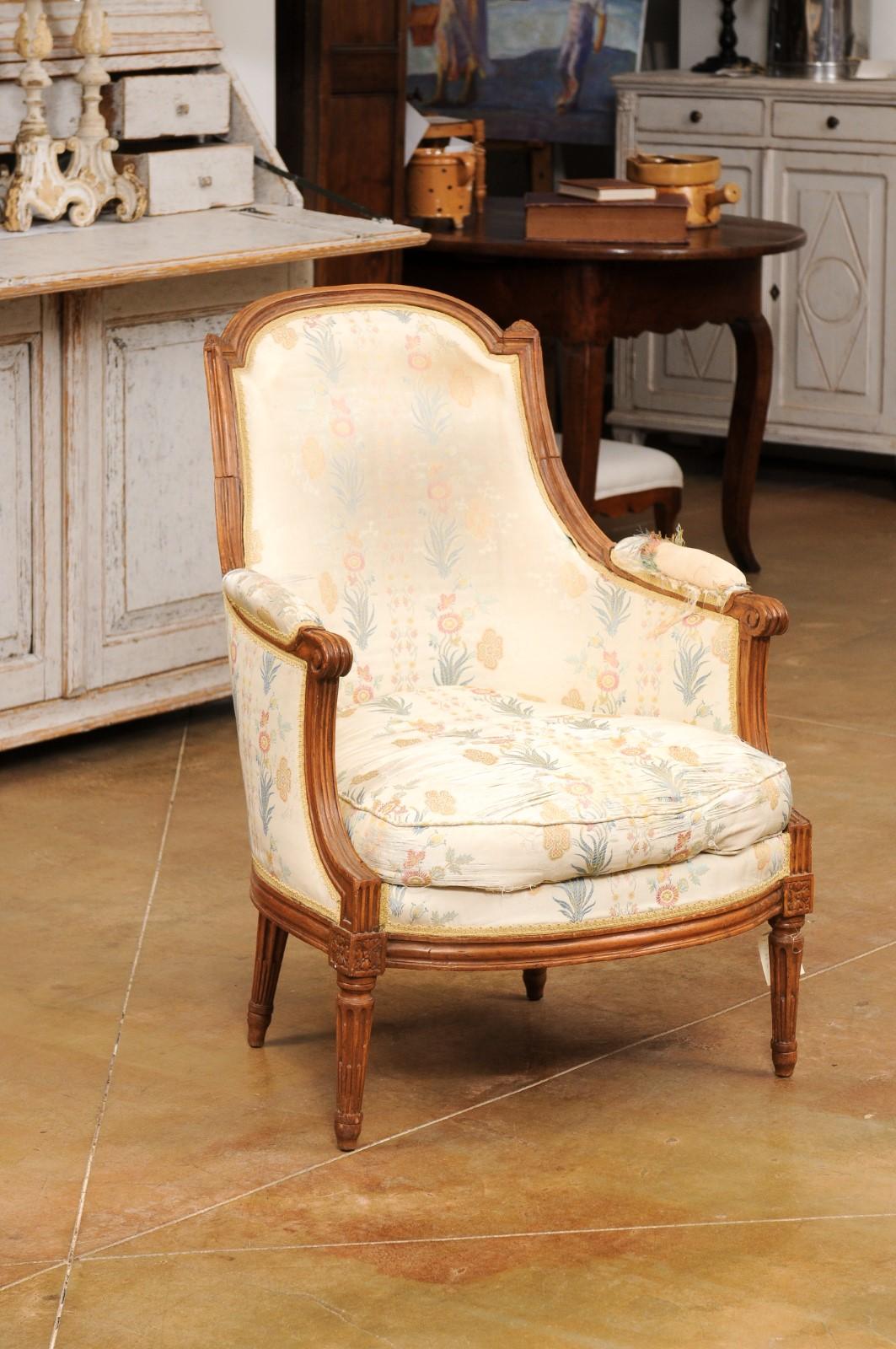 Carved French Louis XVI Period Late 18th Century Walnut Bergère Chair with Curving Back For Sale
