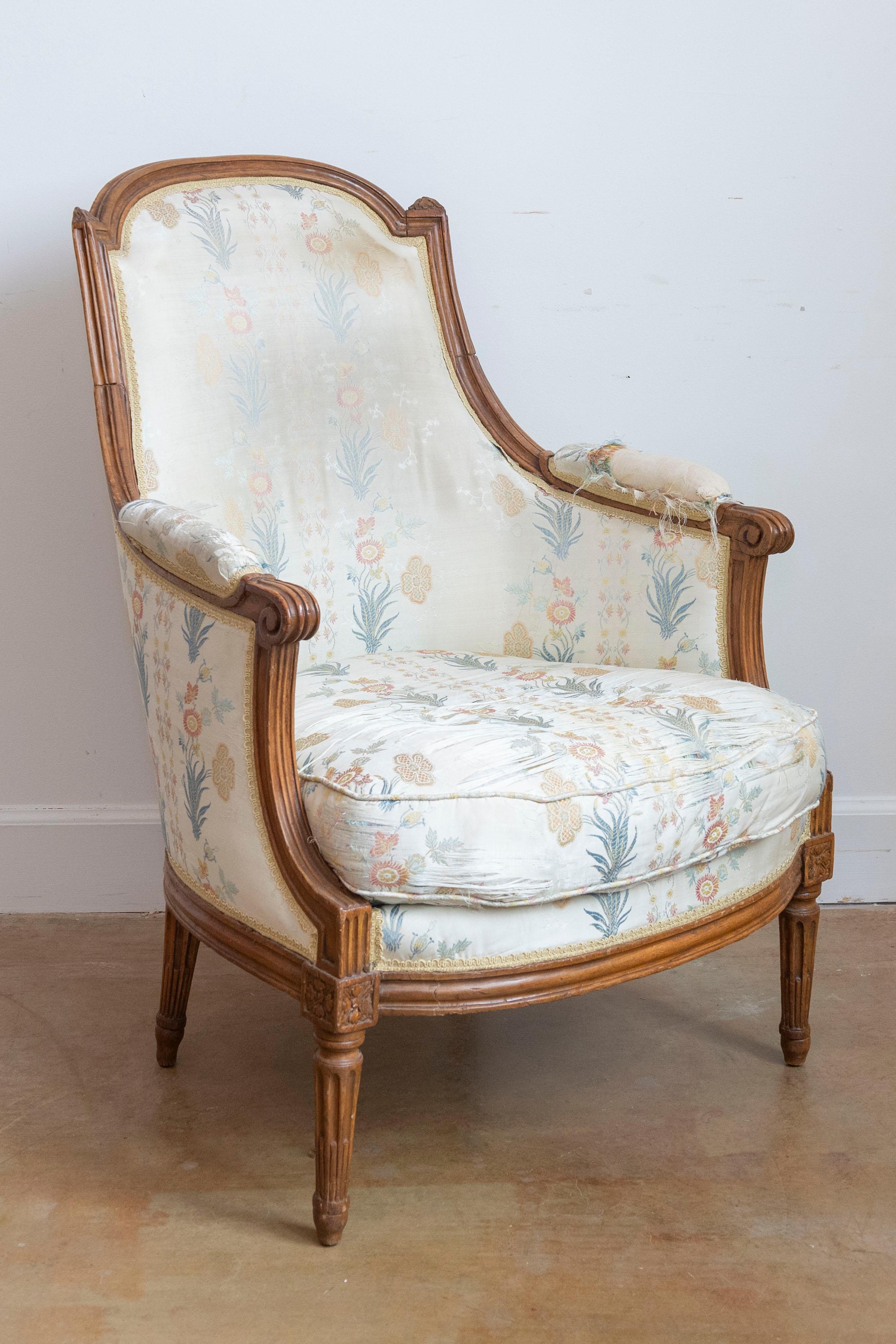 Carved French Louis XVI Period Late 18th Century Walnut Bergère Chair with Curving Back For Sale