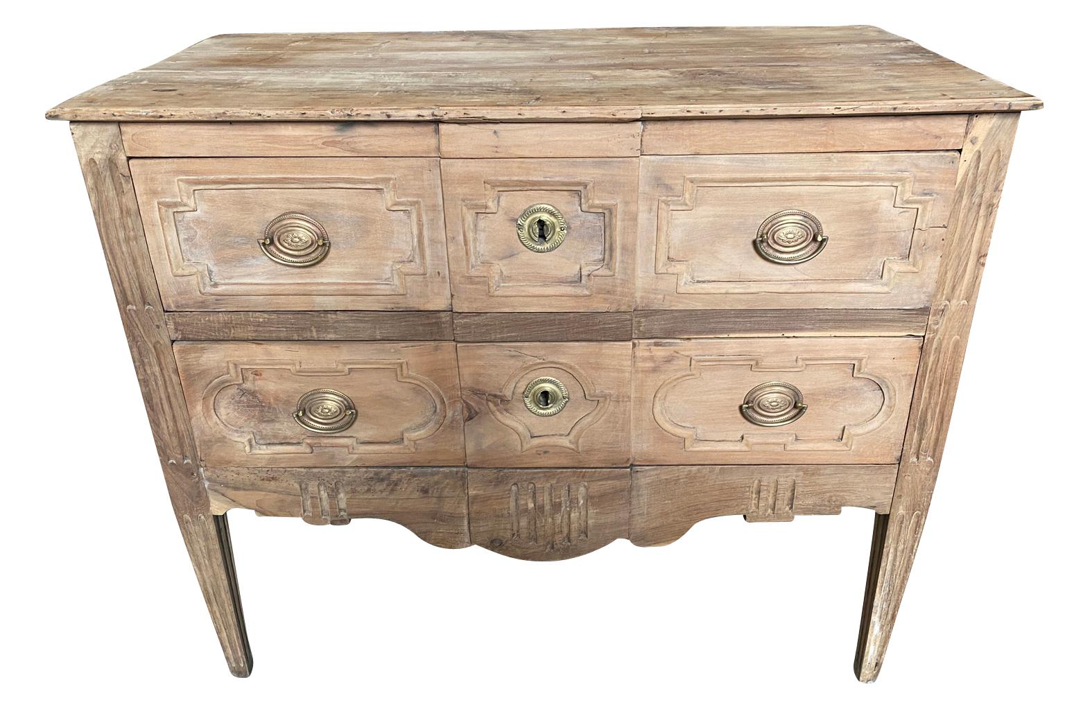 A very lovely Louis XVI period Sauteuse commode from the Provence region of France. Beautifully constructed from walnut having 2 drawers with carved fascias over tapered legs. Perfect as a bedside cabinet or converted into a bathroom vanity.