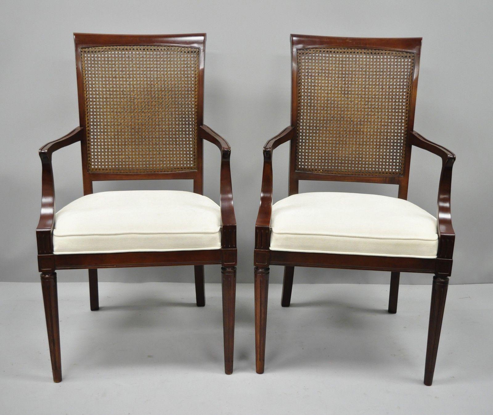 Set of six French Louis XVI style cane back cherrywood dining chairs. Item features four side chairs, two armchairs, dark cherry stain, cane backs, solid wood construction, tapered legs, and quality American craftsmanship, circa late 20th century.