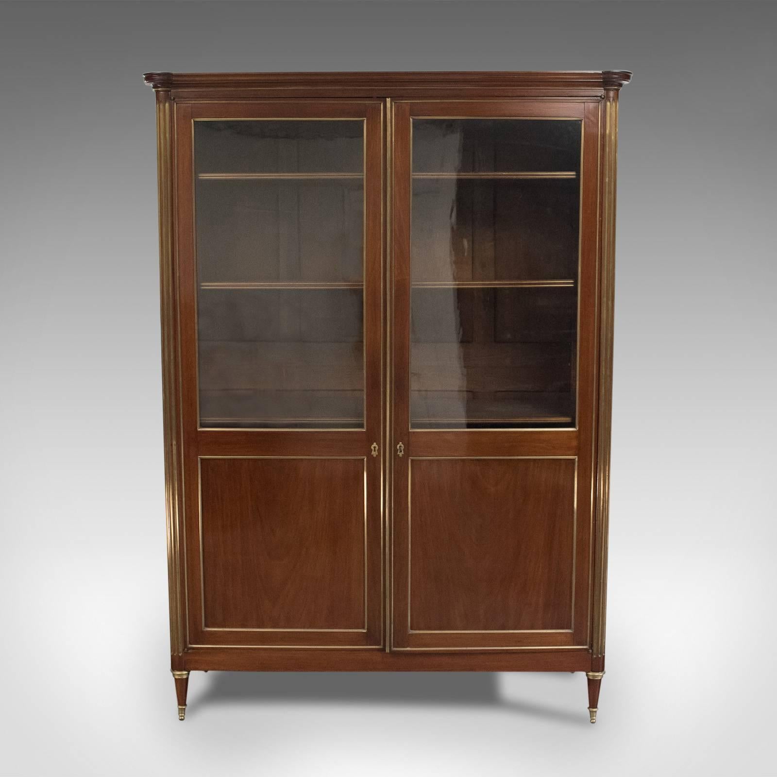 This is a 19th century, French, Louis XVI revival, two-door bookcase, vitrine or cabinet dating to circa 1880.

Hand built to the highest level of craftsmanship
In mahogany with excellent colour and finish
Accentuated with bronzed beading and