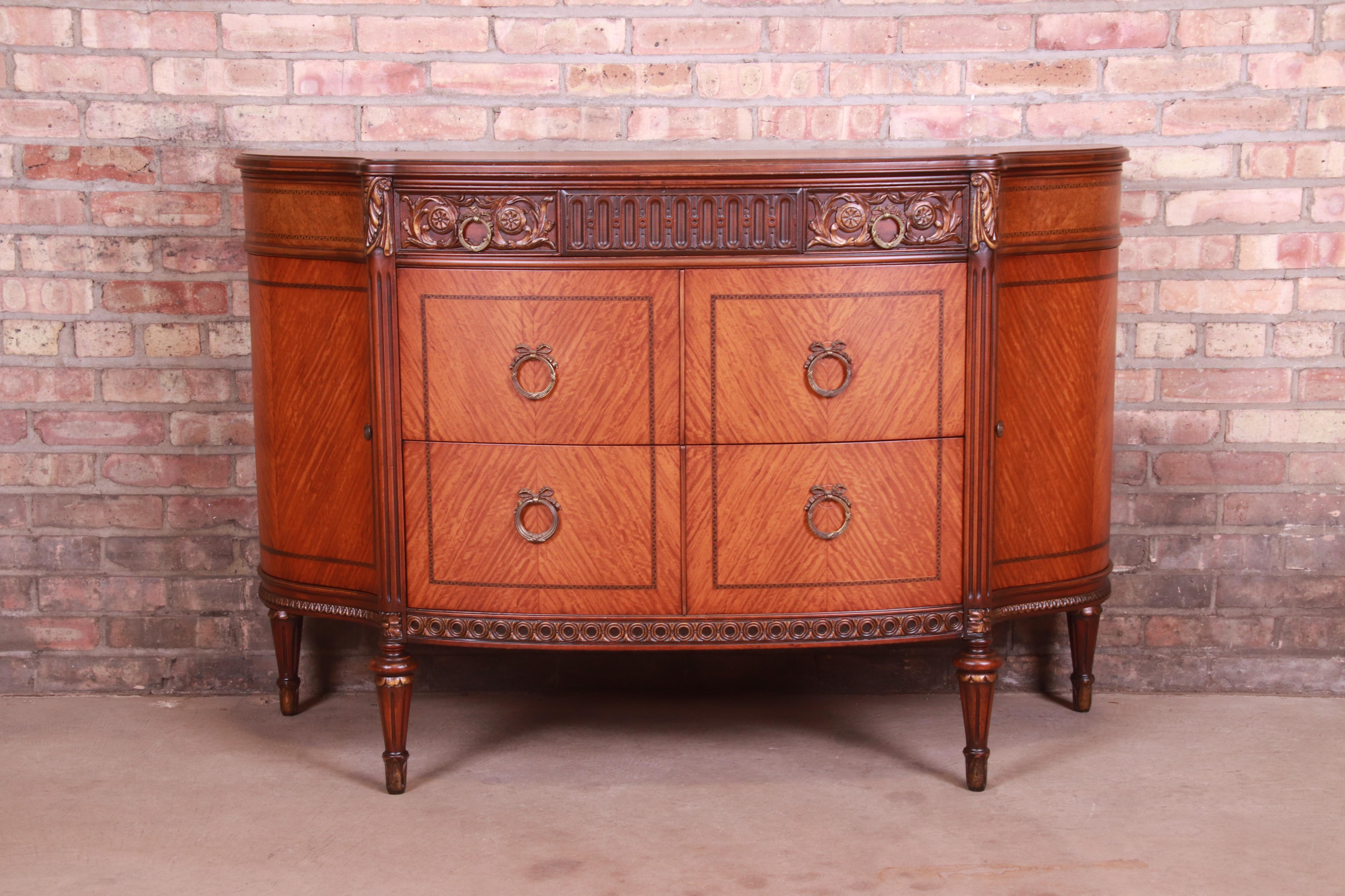 A gorgeous antique French Louis XVI style demilune dresser chest

By Saginaw Furniture

USA, Circa 1920s

Inlaid satinwood and mahogany, with original brass hardware.

Measures: 52