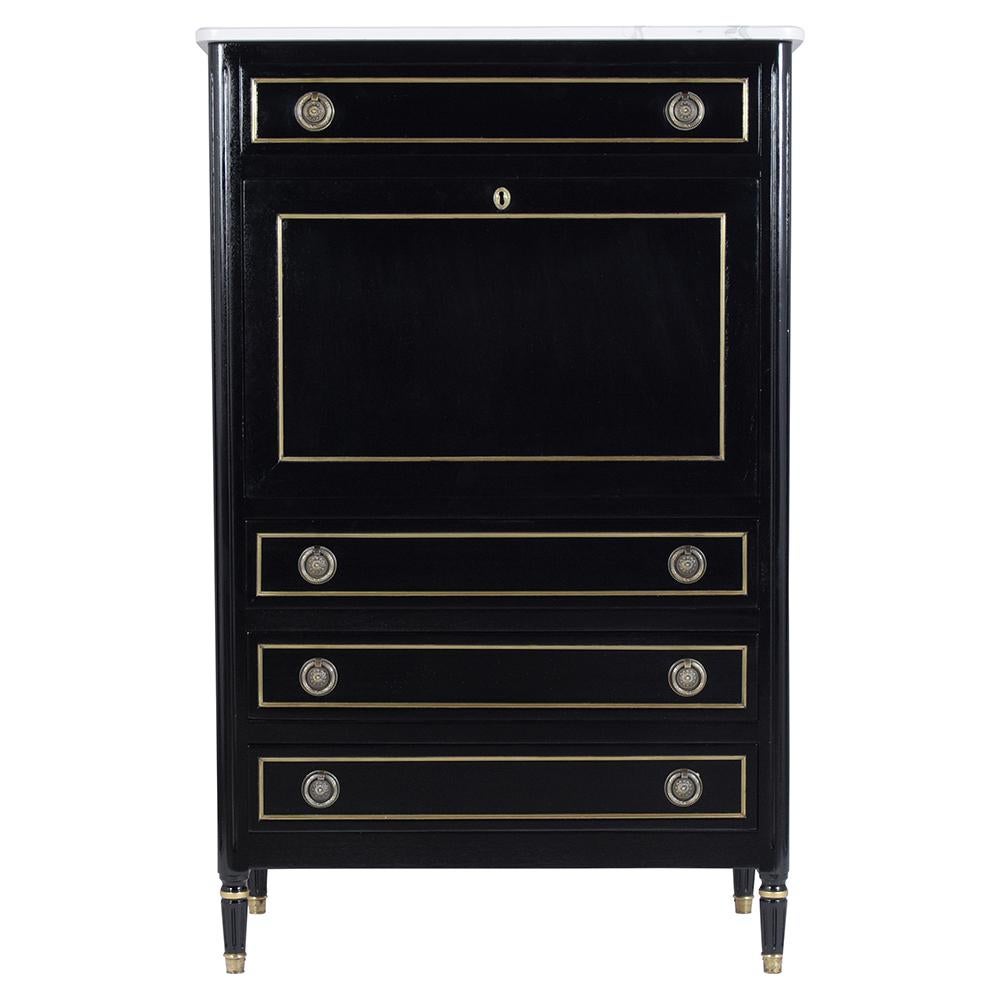 An elegant French Antique Louis XVI Secretary crafted from mahogany wood. This extraordinary piece features newly ebonized color with a lacquered finish and eye-catching brass molding accents details a new quartz white marble top a drop front desk