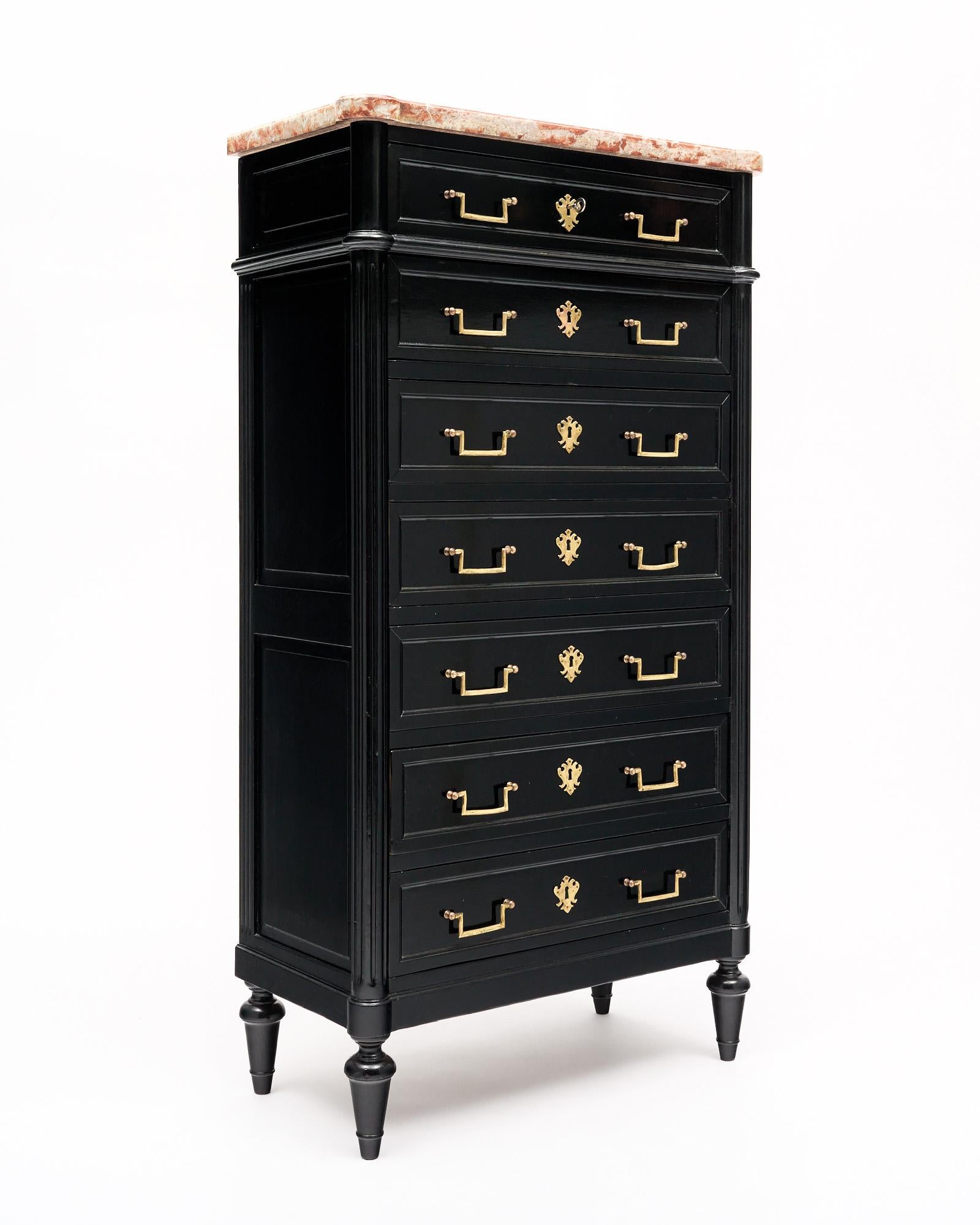 French antique semainier in the Louis XVI style. This piece is made of solid wood construction, primarily mahogany that has been fully ebonized and finished with a lustrous French polish of museum-quality. There are seven dovetailed drawers