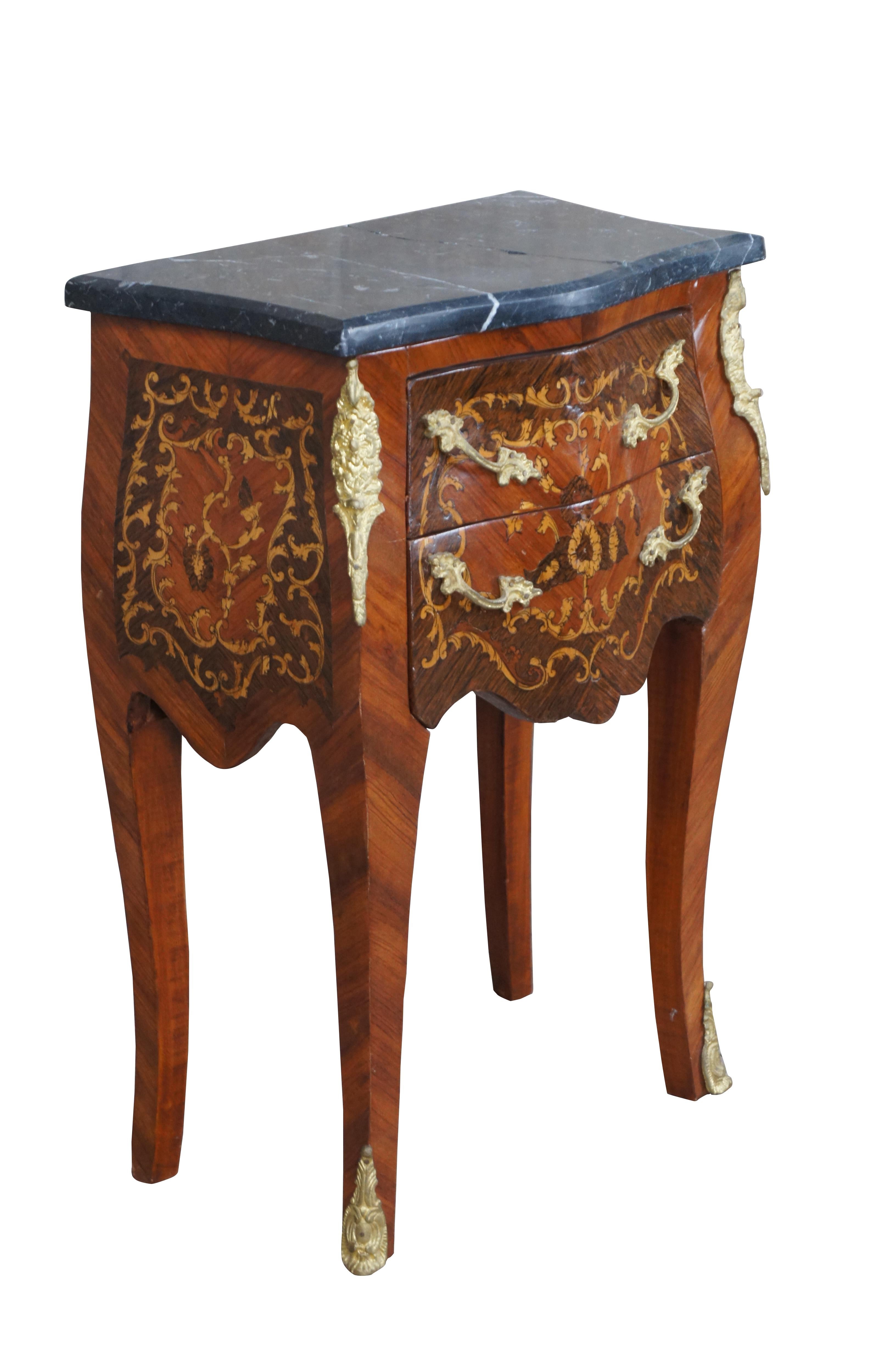 Mid 20th Century French Louis XVI style bedside stand / bombe chest / commode / nightstand / end table.  Made of walnut featuring a marquetry design of flowers and acanthus leaves with ormolu hardware and marble top.

Dimensions:
16