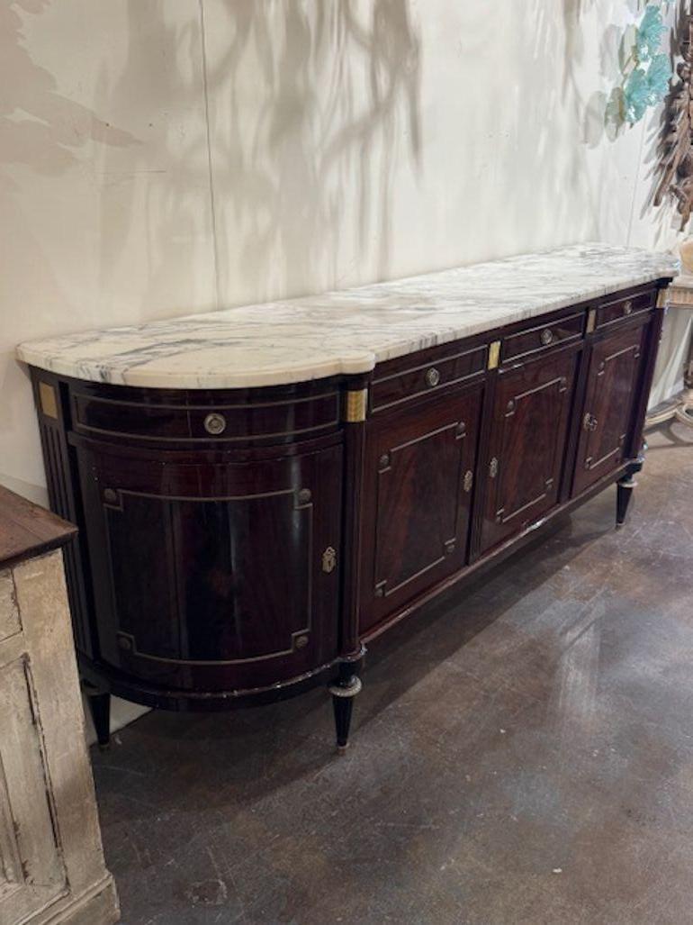Early 20th century French Louis XVI style mahogany D-shape sideboard. You're diving into a world of refined symmetry and regal craftsmanship—French Louis XVI–style mahogany D-shape sideboards (also called demilune or enfilade sideboards) are prized