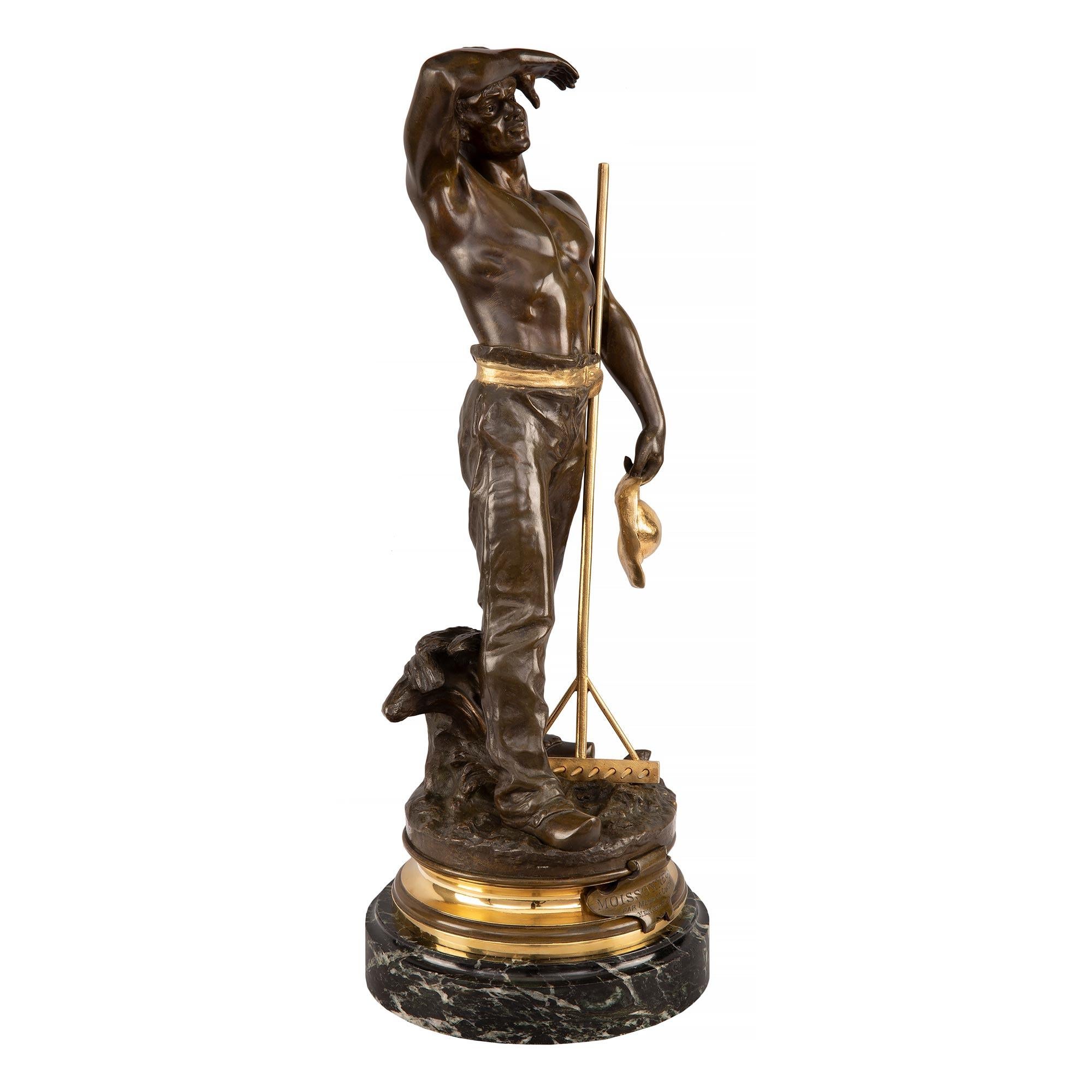 A wonderful French Turn of the Century Louis XVI st. patinated bronze, ormolu and Vert de Patricia marble statue named Moissonneur, by Maurice Constant. The statue is raised by a circular Vert de Patricia marble base with a fine mottled border. The