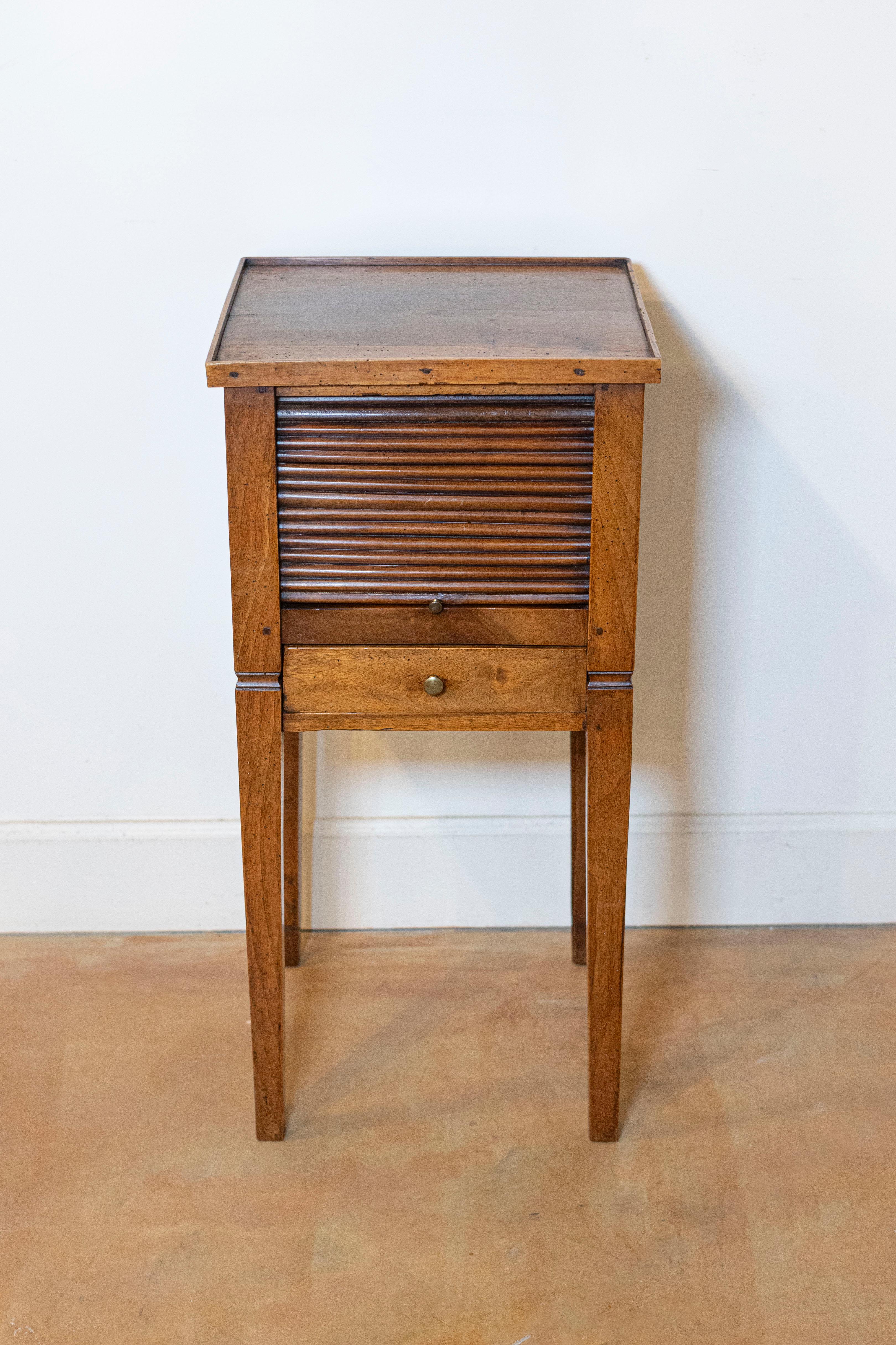 A French Louis XVI style walnut bedside table circa 1890 with tambour door, single drawer and tapering legs. Step back in time with this elegant French Louis XVI style walnut bedside table, dating back to circa 1890. Known as a 