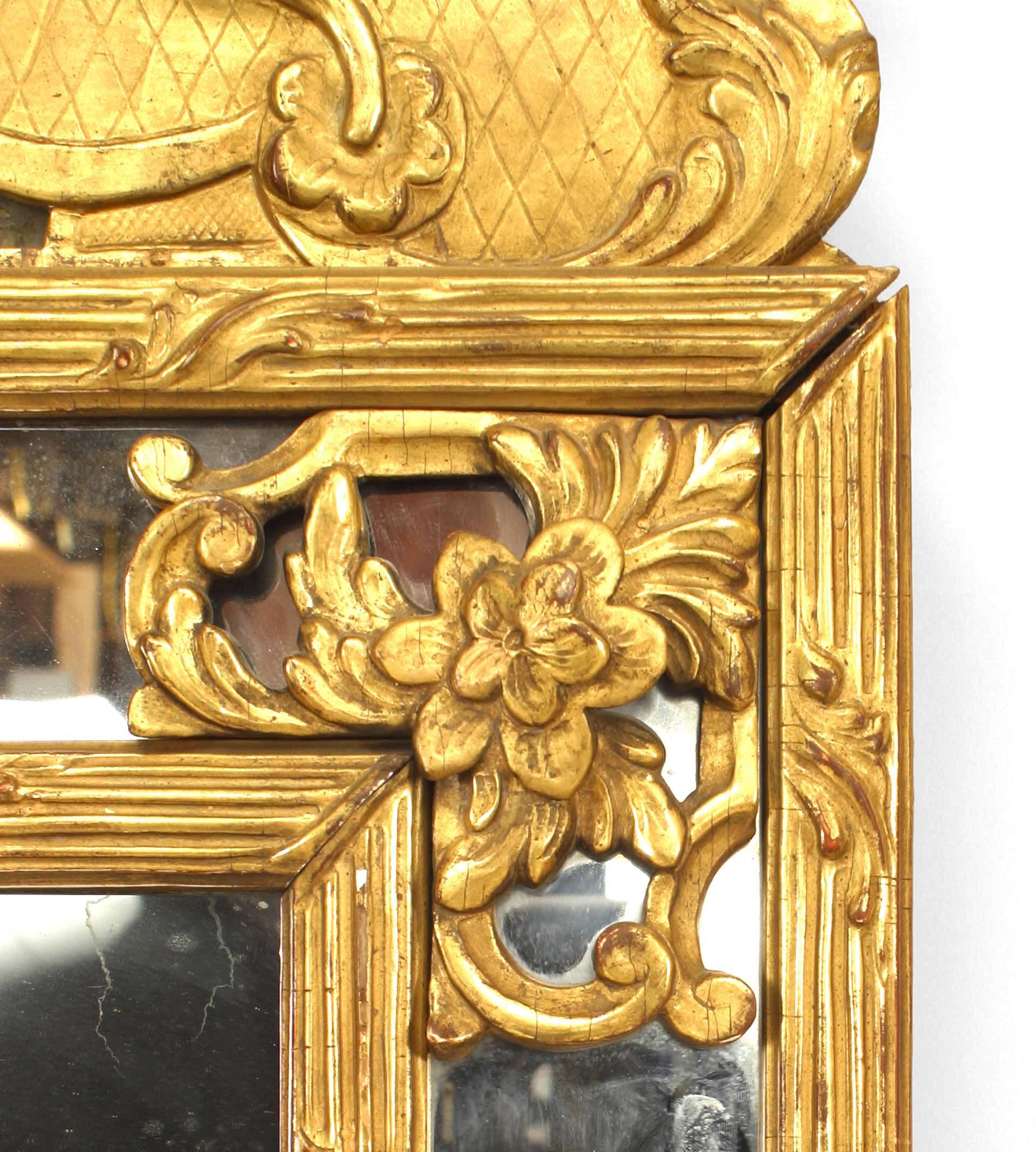 French Louis XVI-style (19th Century) rectangular giltwood wall mirror with a mirrored border and an added (18th Century) pediment top with a carved shell form relief.
