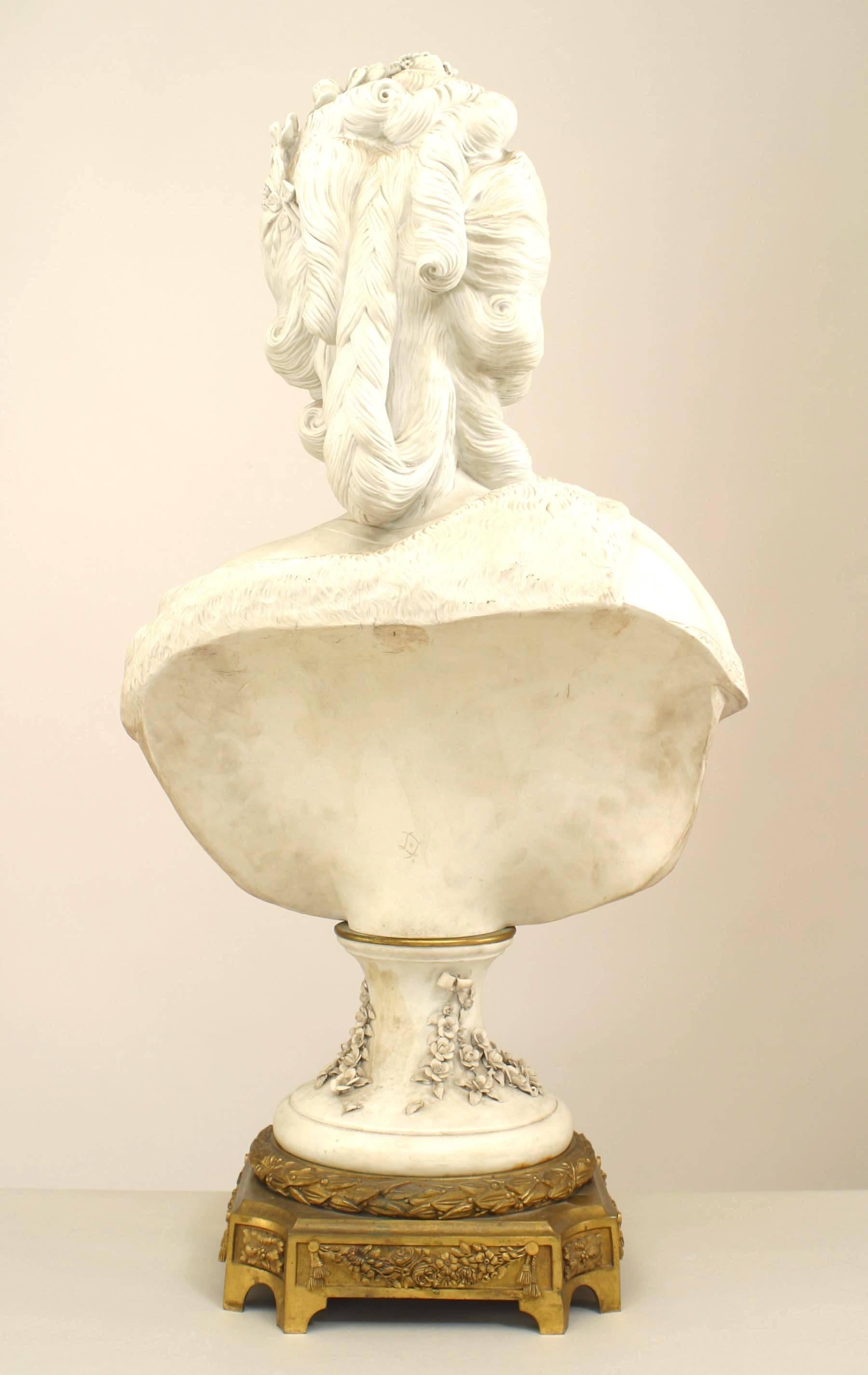 French Louis XVI style (19th Cent) parium bust of Marie Antoinette wearing a robe and mounted on a festooned pedestal and resting on a bronze base (signed with Sevre mark)

