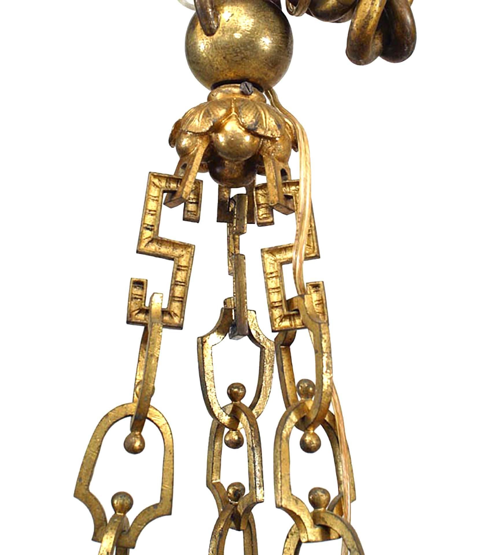 French Louis XVI-Style (19th Century) bronze dore 9 scroll arm chandelier with 3 cupids playing instruments and flame top
