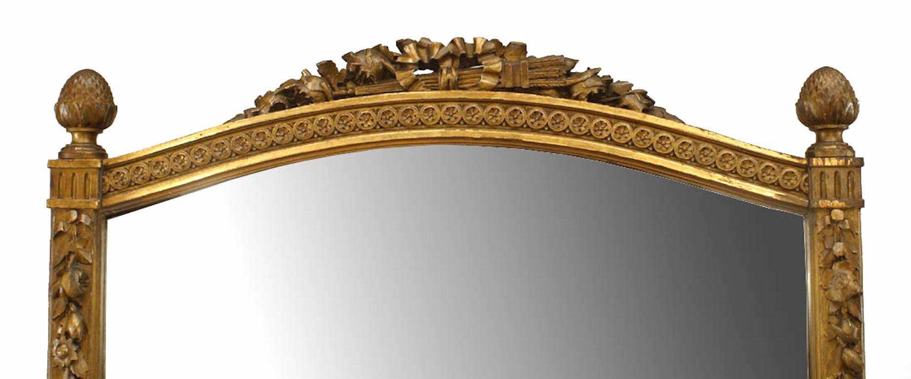 French Louis XVI-style (19th Century) giltwood cheval mirror with finials and a carved crest.
