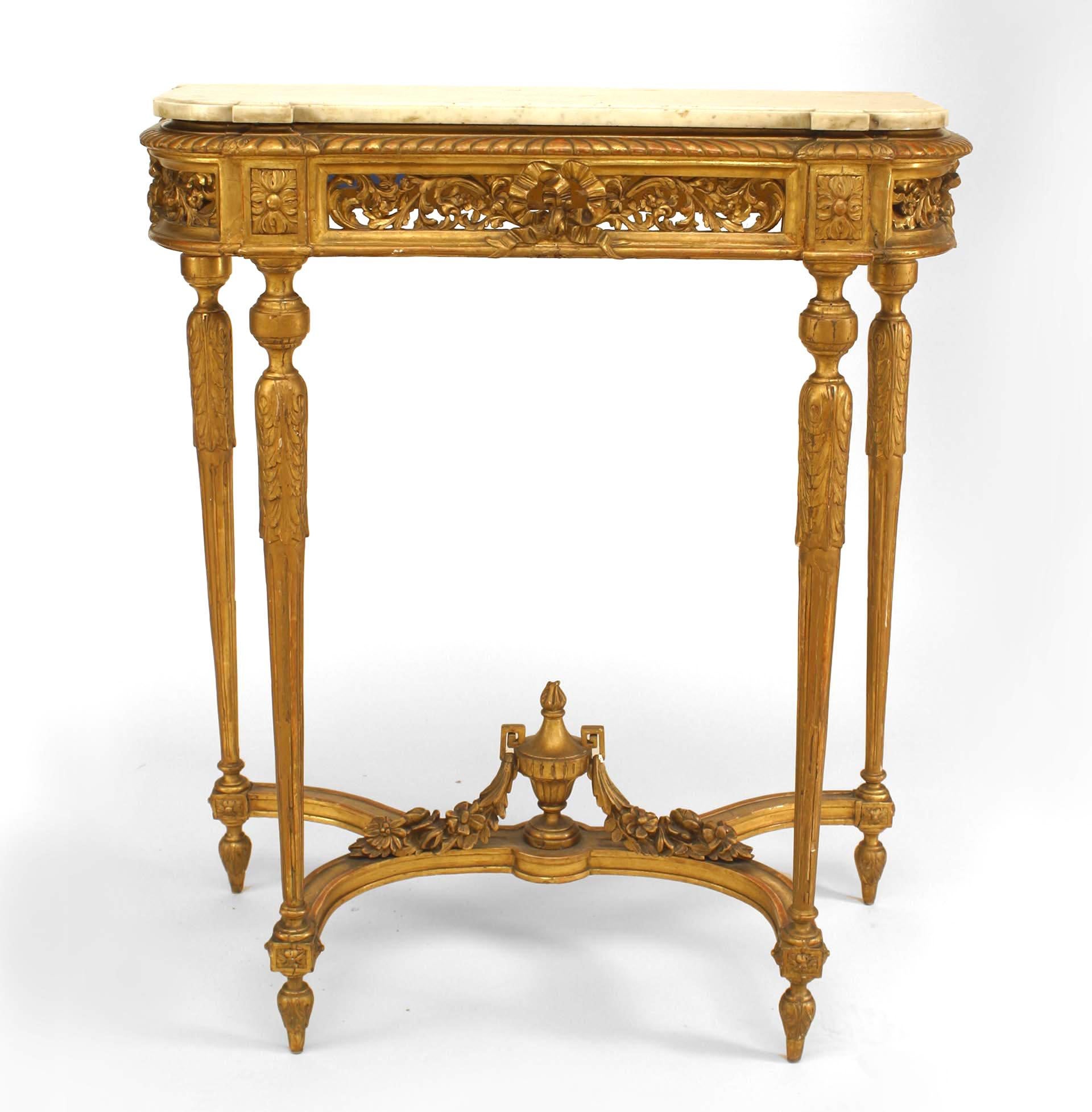French Louis XVI style (19th century) gilt console table with filigree apron, urn stretcher, and white marble top.
 