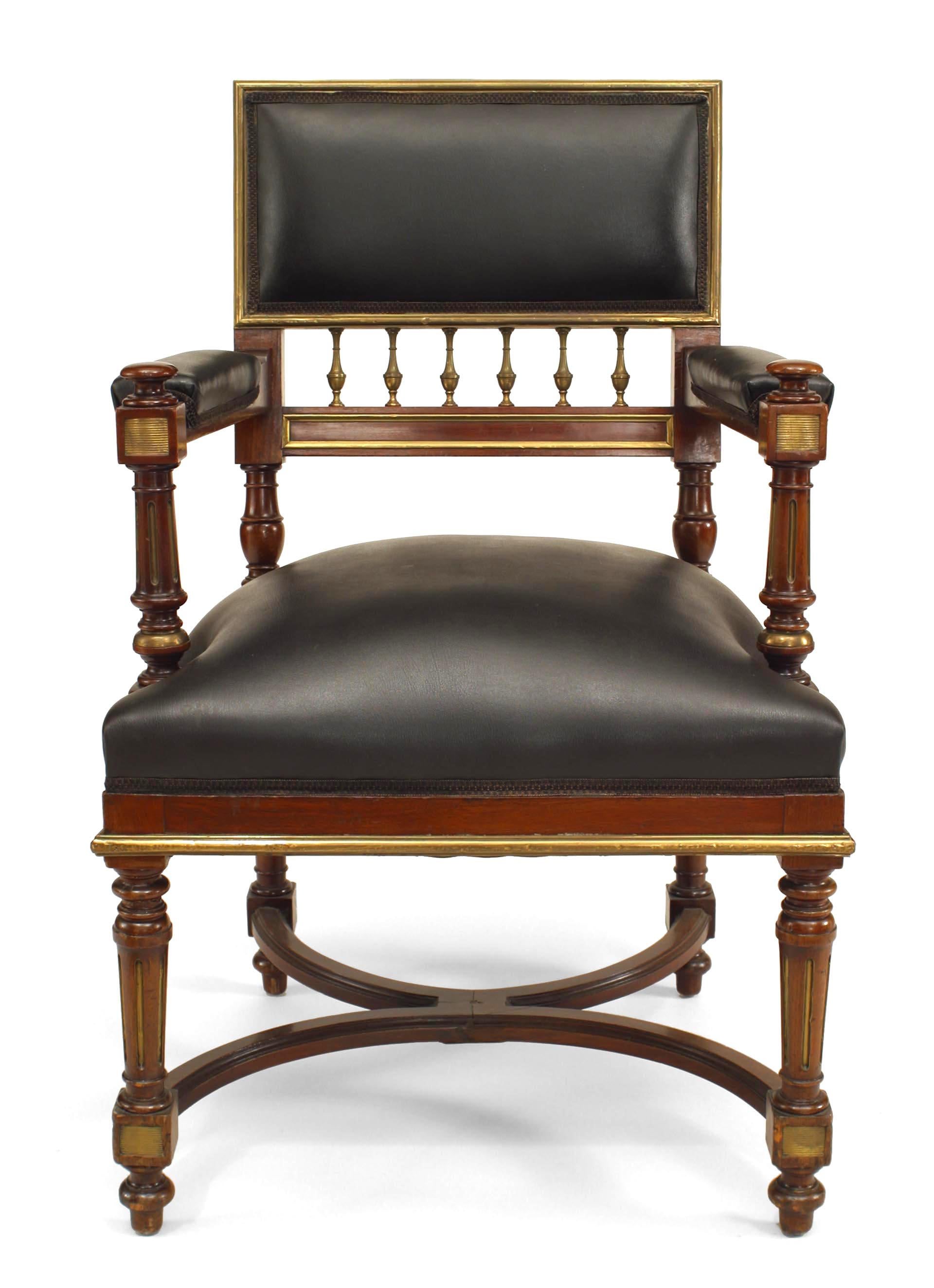 Pair of French Louis XVI-style (19th Century) mahogany arm chairs with brass trim, spindle detail, and black leather upholstery.
