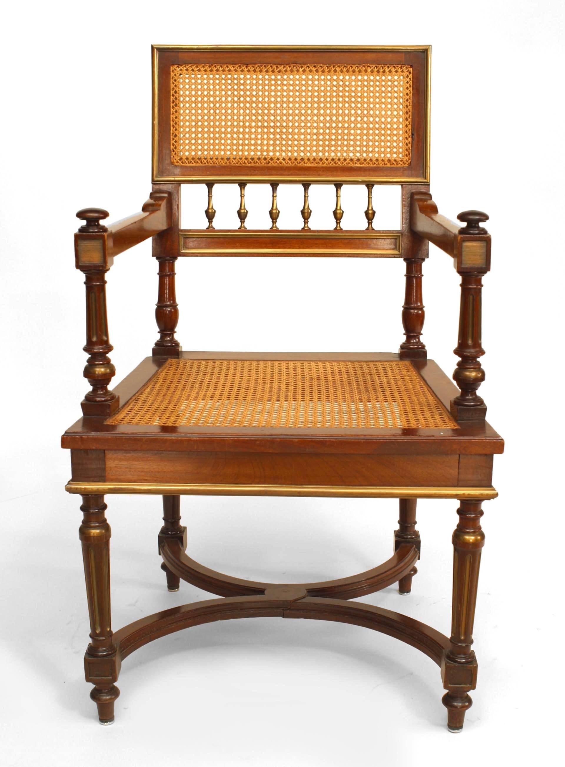 French Louis XVI style (19th Cent) mahogany square back open arm chair with bronze trim and cane seat & back with a stretcher.
