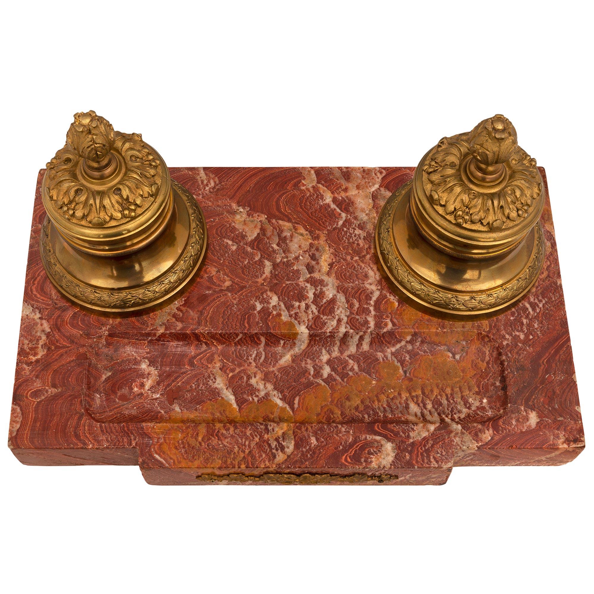 A striking French 19th century Louis XVI st. Alabastro marble and ormolu inkwell. The inkwell is raised by elegant topie shaped ormolu feet below the beautiful Alabastro marble support showcasing the most decorative grain and displaying a sculpted
