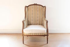 French Louis XVI Style 19th Century Walnut Bergère à Oreilles with Carved Roses