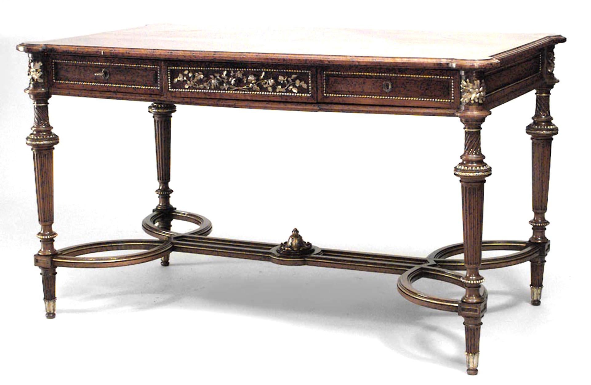 French Louis XVI style (19th Century) walnut center table with carved gilt trim and apron with carved floral design and open stretcher.
