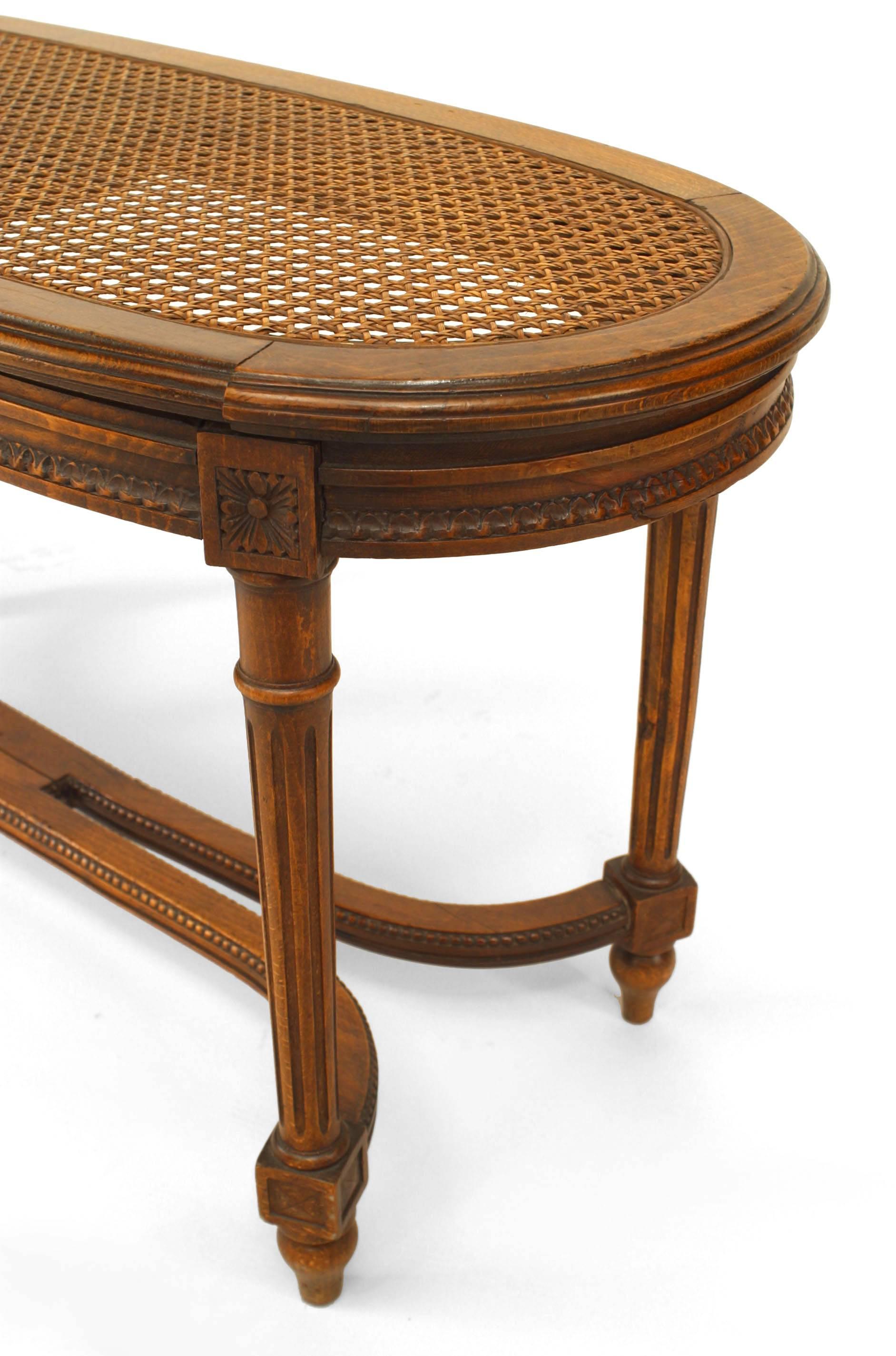 French Louis XVI style (19th Century) walnut oval shaped bench with double stretcher and inset cane seat.

