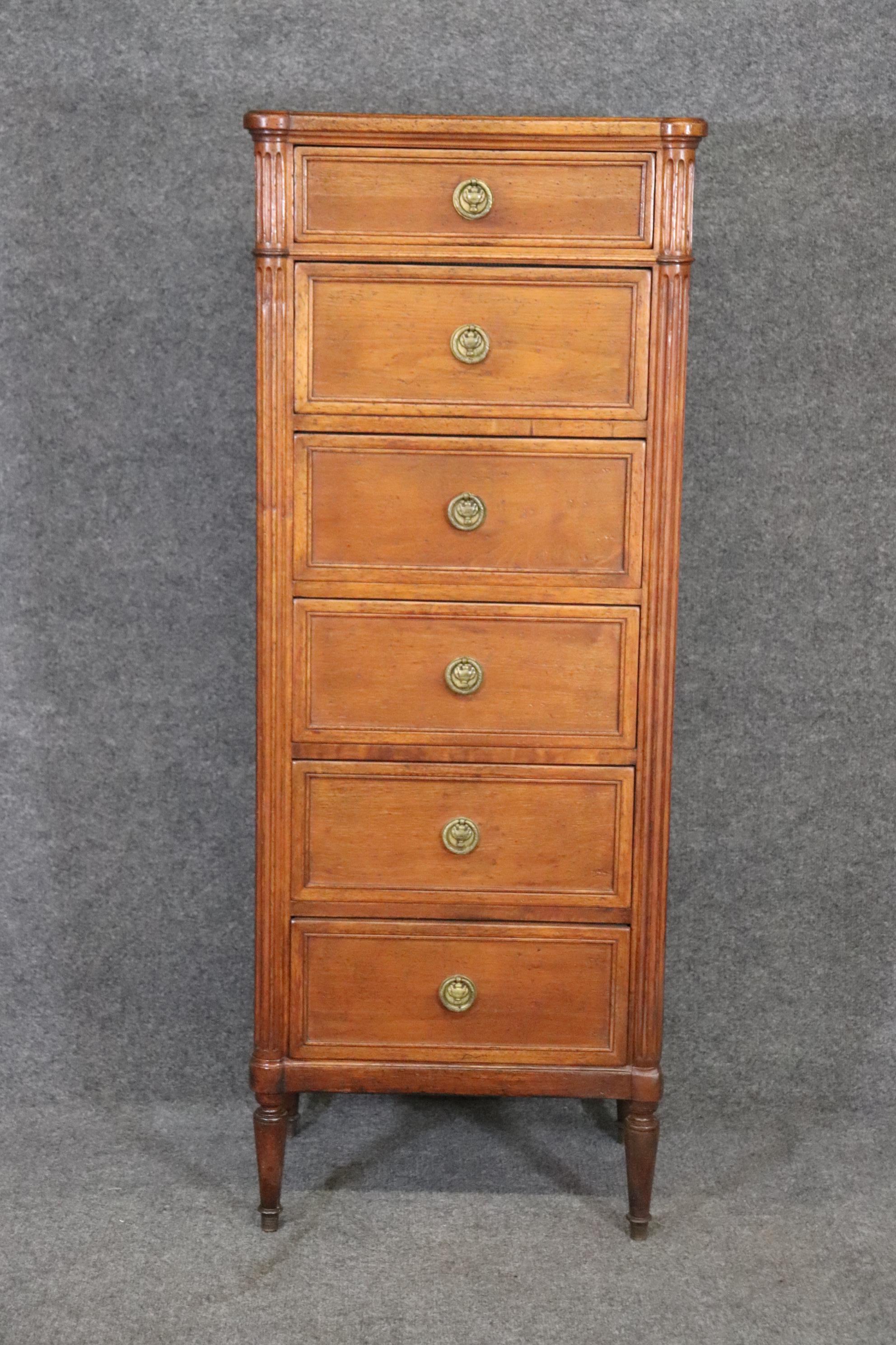 This Louis XVI style lingerie chest is made of the highest quality and looks like it could possibly be made by the world famous furniture company Baker. This chest is made of high end walnut and accompanied by brass hardware. This is the perfect