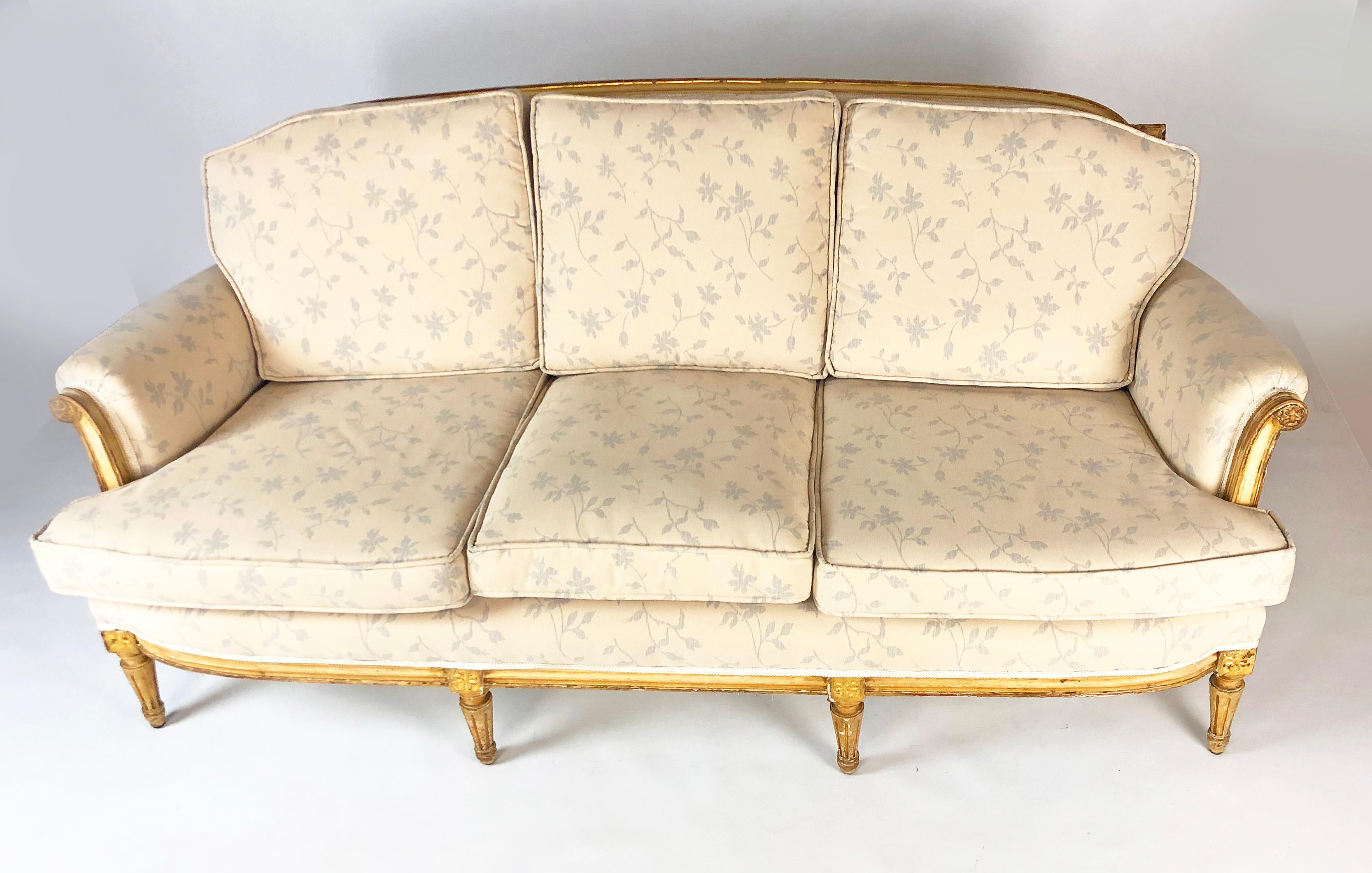 Outstandingly comfortable and attractive antique French Louis XVI style sofa, probably made during the last quarter of the 19th century, if not earlier. It features 8 carved and gilt beechwood legs and frame with lovely patina. It has depth of
