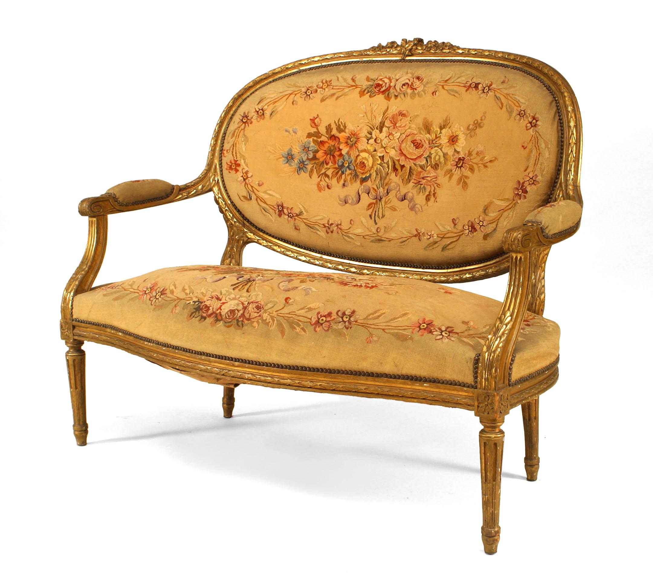 French Louis XVI-style, 19th century gilt oval back Aubusson upholstered loveseat.
  